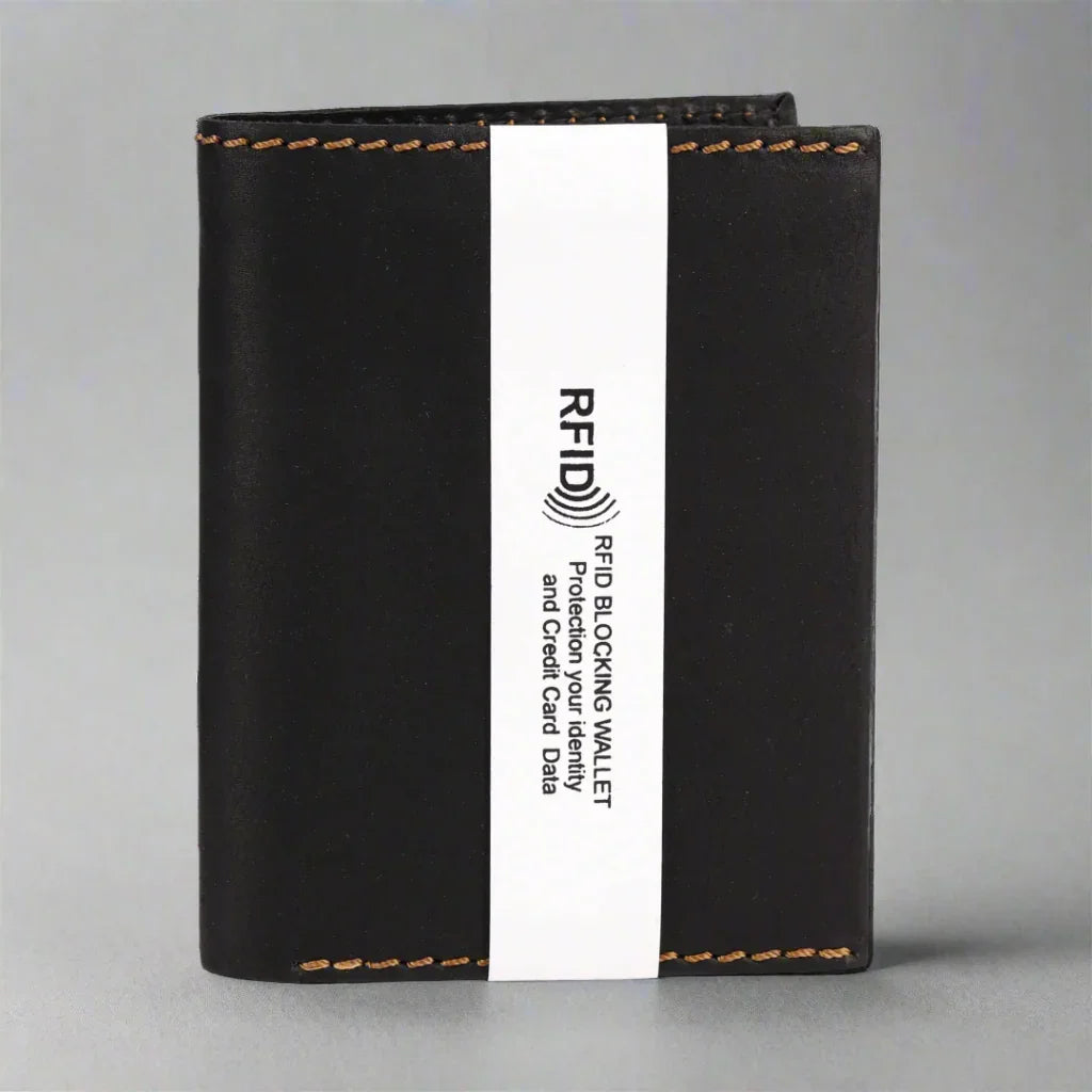 Black RFID blocking wallet with brown stitching and white label on gray background