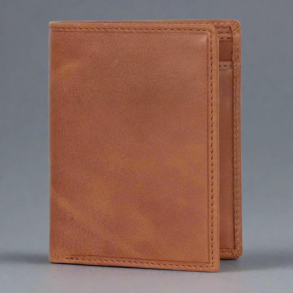 Beige leather bifold wallet standing on gray background, minimal stitch detail visible