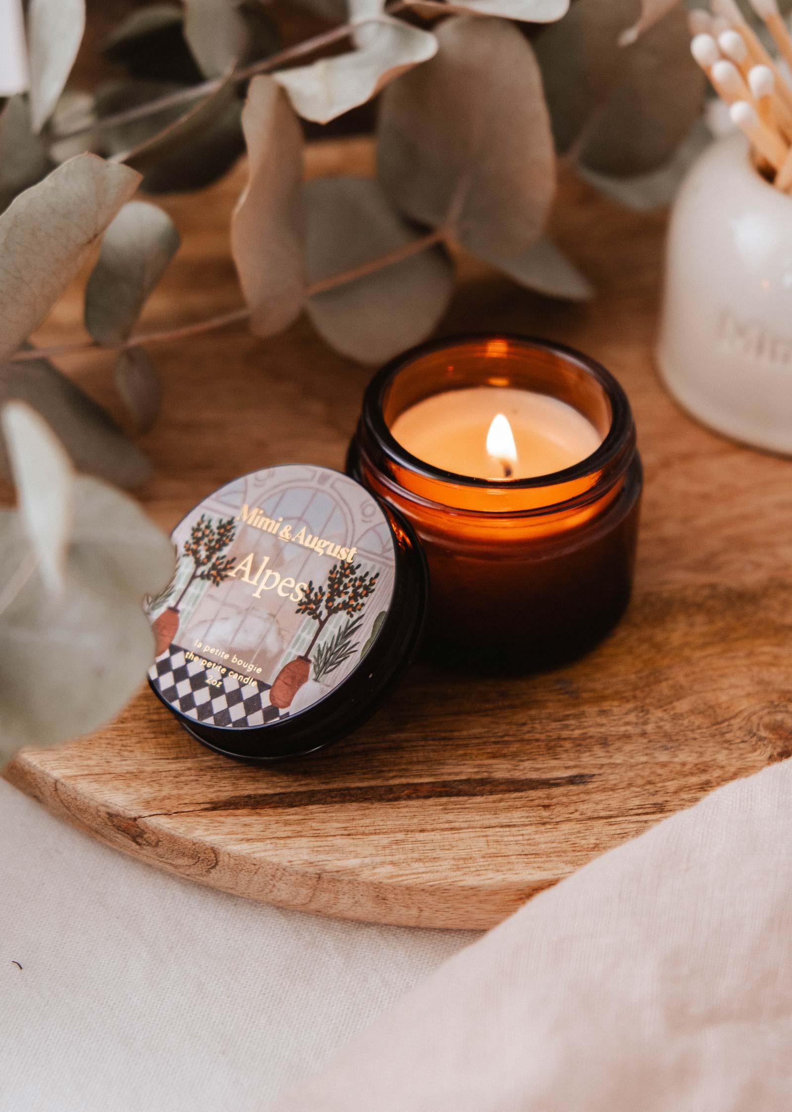 Mimi & August Alpes mini candle burning in amber jar on wooden tray with eucalyptus