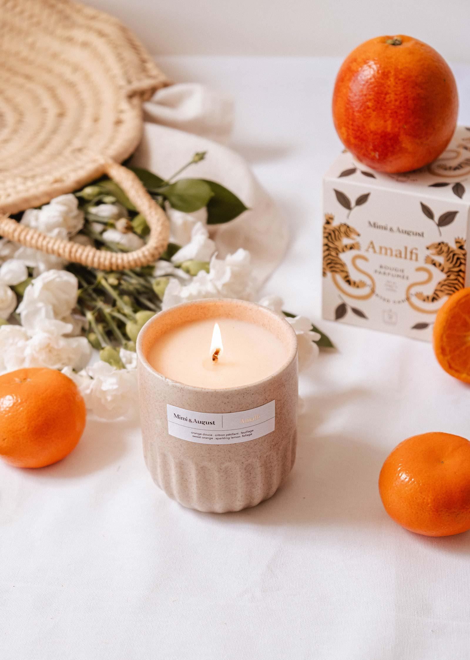 Mimi & August Amalfi reusable candle with oranges, white flowers, and decorative box on table