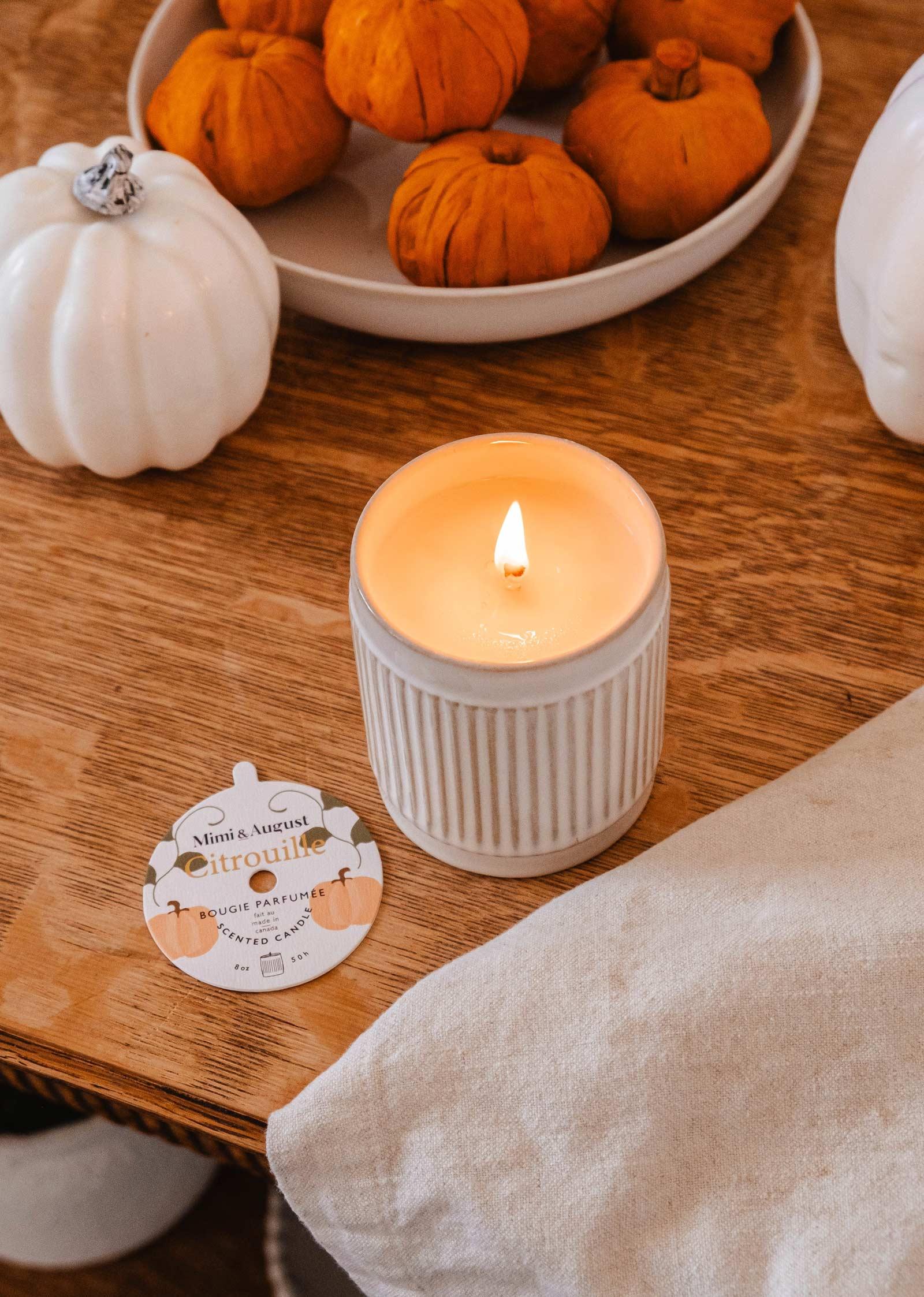 Citrouille reusable candle in white jar on wood table with pumpkins and label