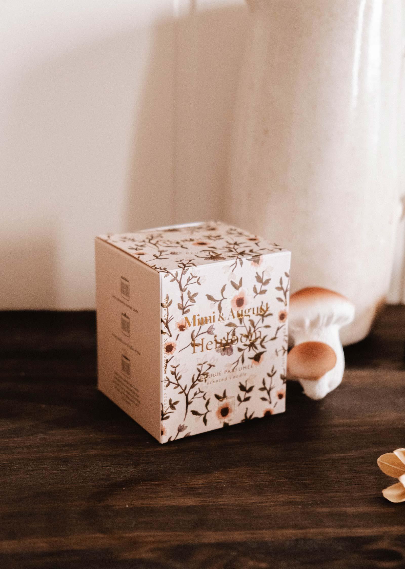 Heirloom soy wax candle box by Mimi & August on wooden table with decorative mushrooms