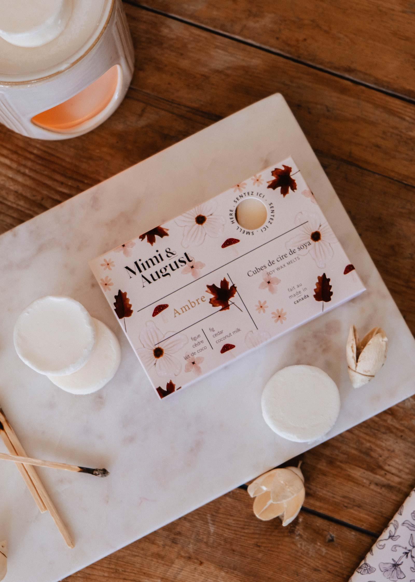 Mimi & August Ambre soy wax melts on marble tray with candle warmer and wood table
