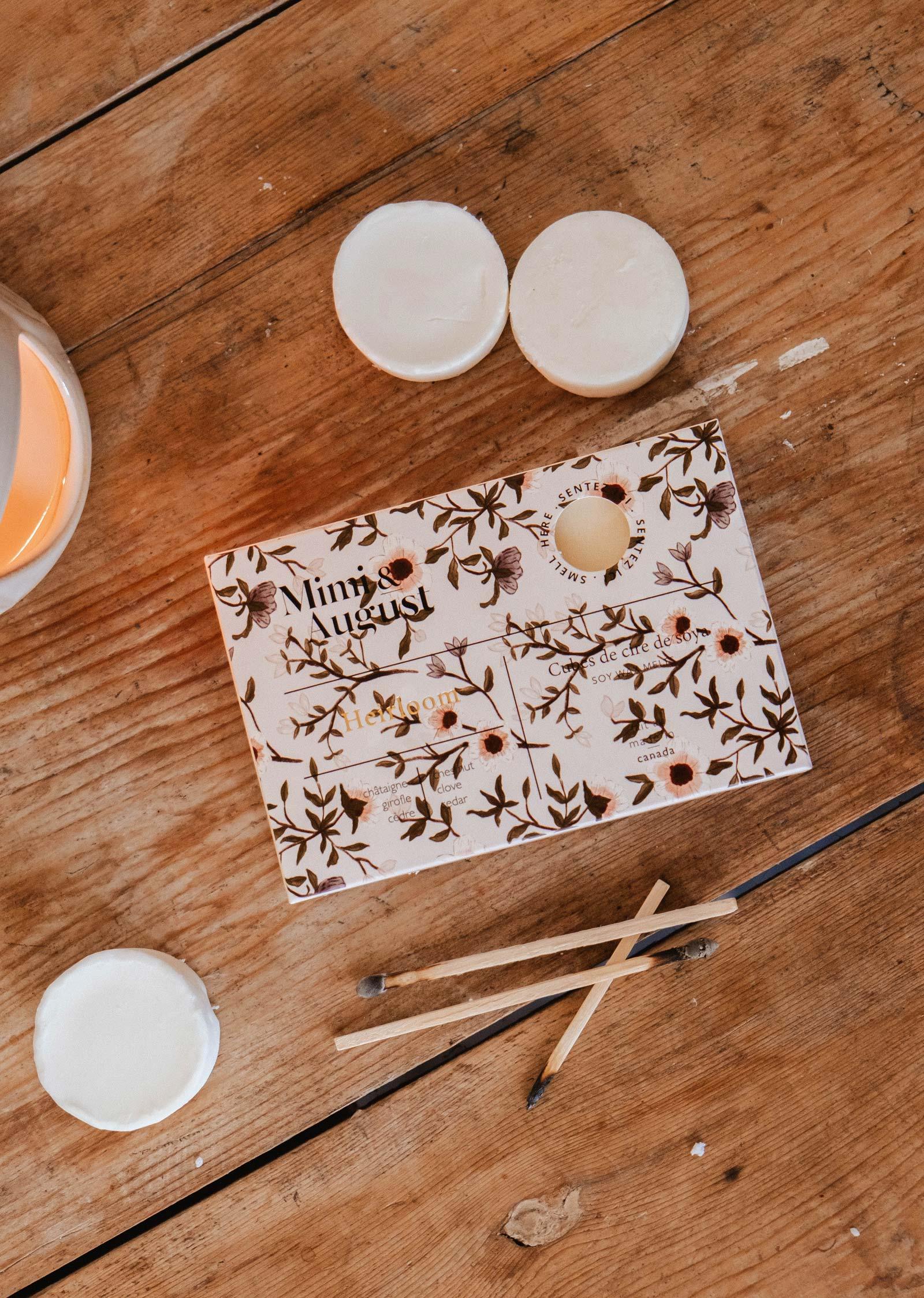 Heirloom soy wax melts by Mimi and August on a wooden table with matches