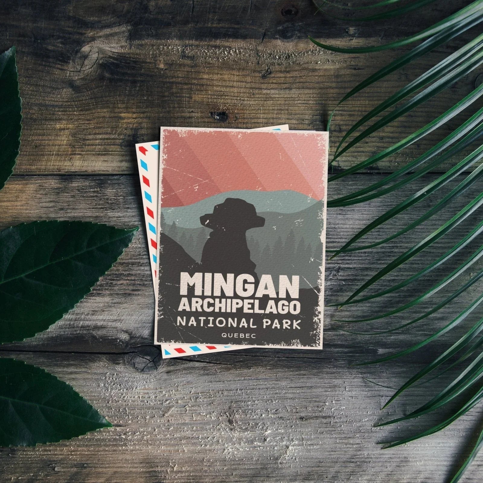 Mingan Archipelago National Park Quebec postcard on rustic wood with green leaves