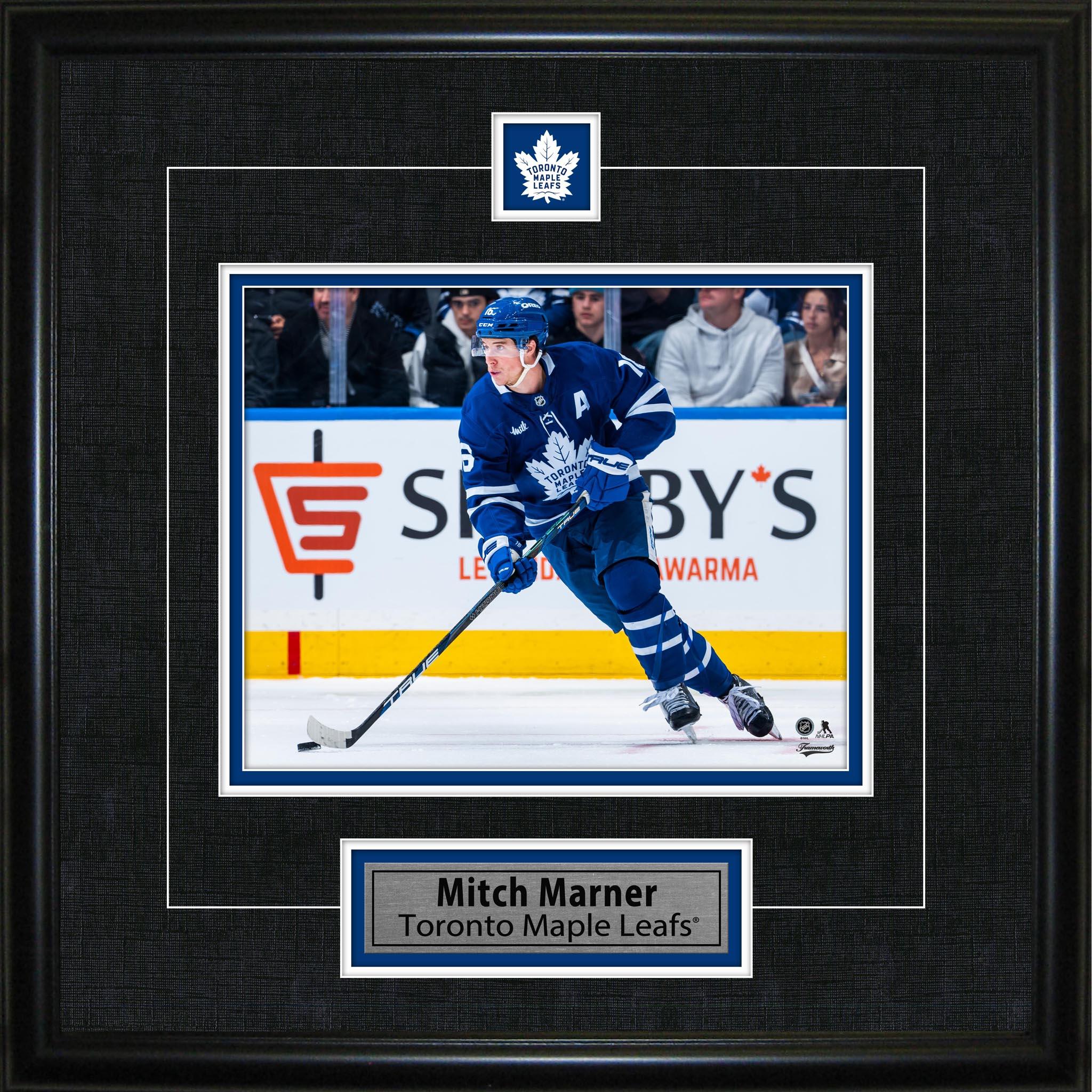 Framed photo of Toronto Maple Leafs player in blue jersey skating on ice with hockey stick