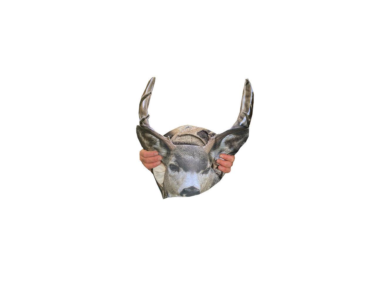 Hands holding a realistic mule deer buck folding decoy with antlers on white background