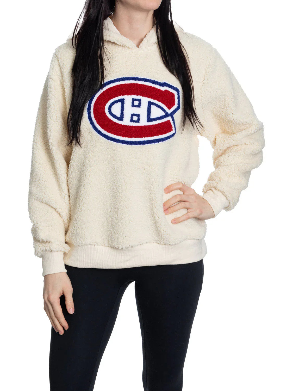 Woman wearing cream Montreal Canadiens sherpa hoodie and black leggings