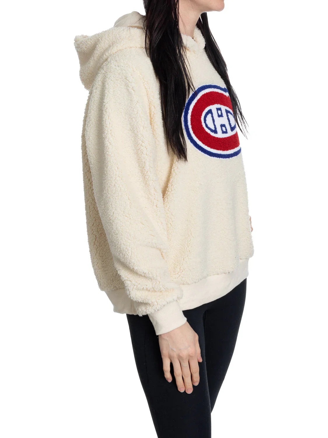Person wearing cream Montreal Canadiens sherpa hoodie and black leggings