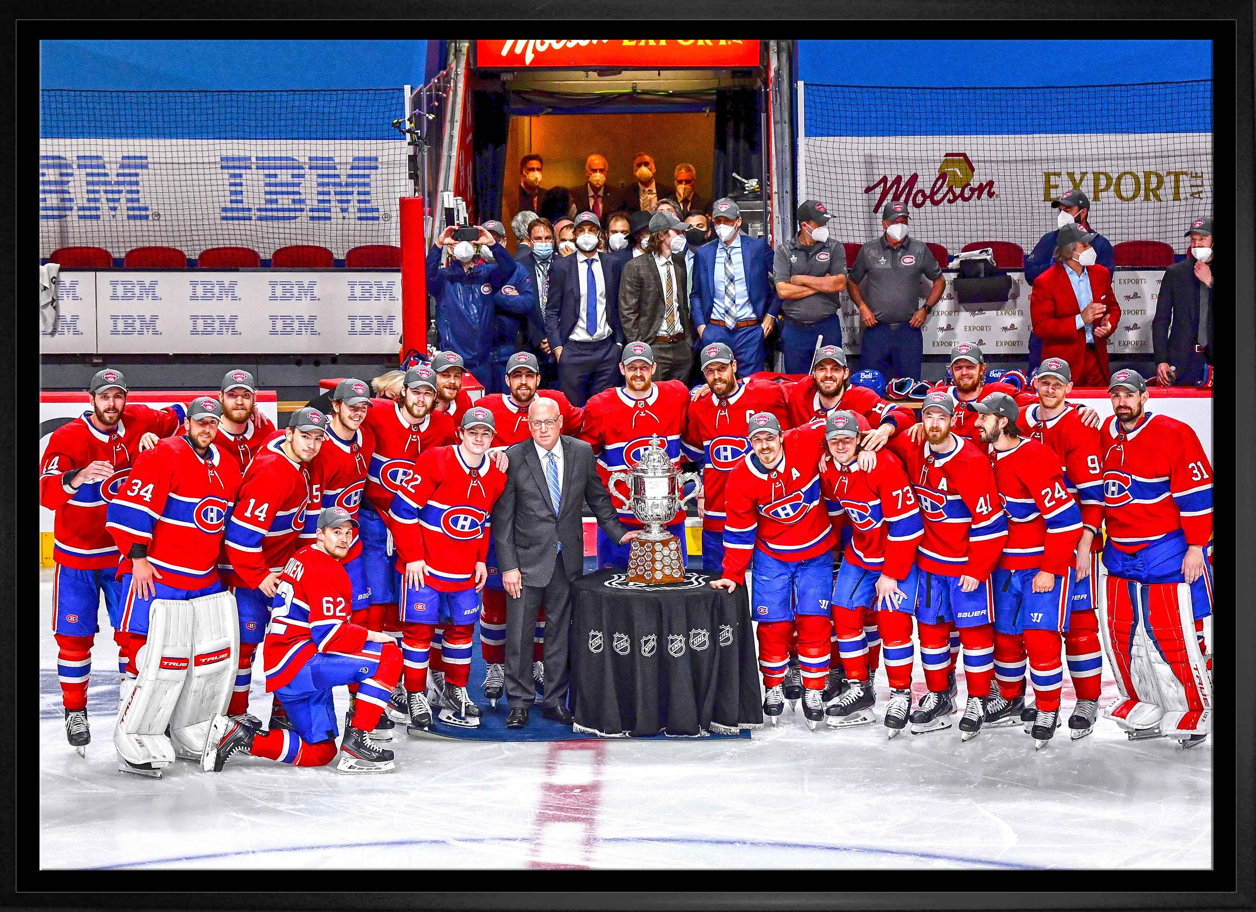 Montreal Canadiens hockey team posing with the NHL trophy on the ice rink