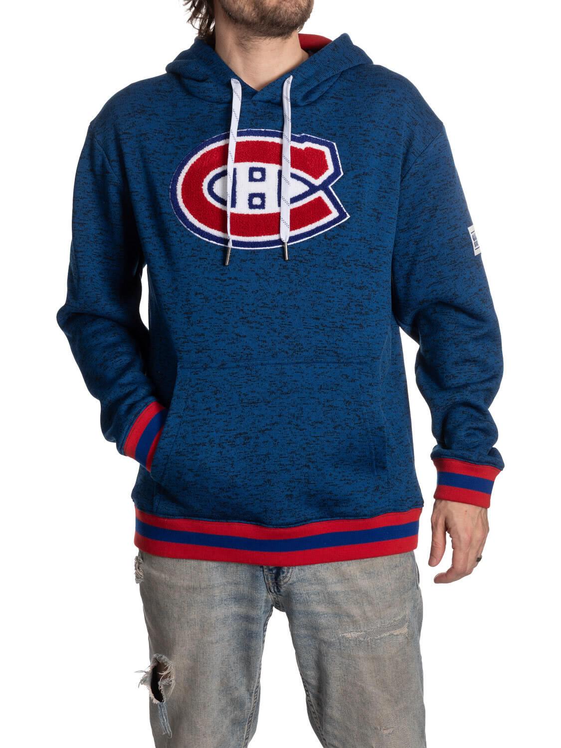 Man wearing blue Montreal Canadiens hoodie with logo and ripped jeans