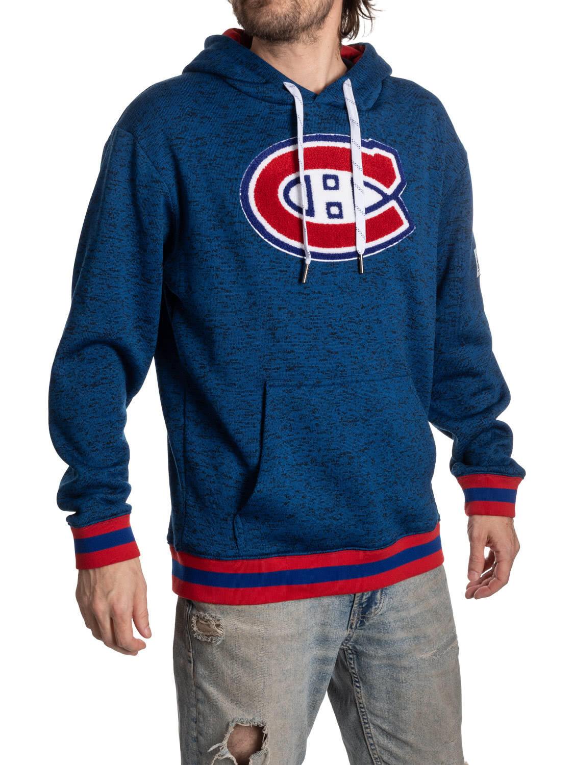 Man wearing a blue Montreal Canadiens hoodie with logo, red stripes, and ripped jeans