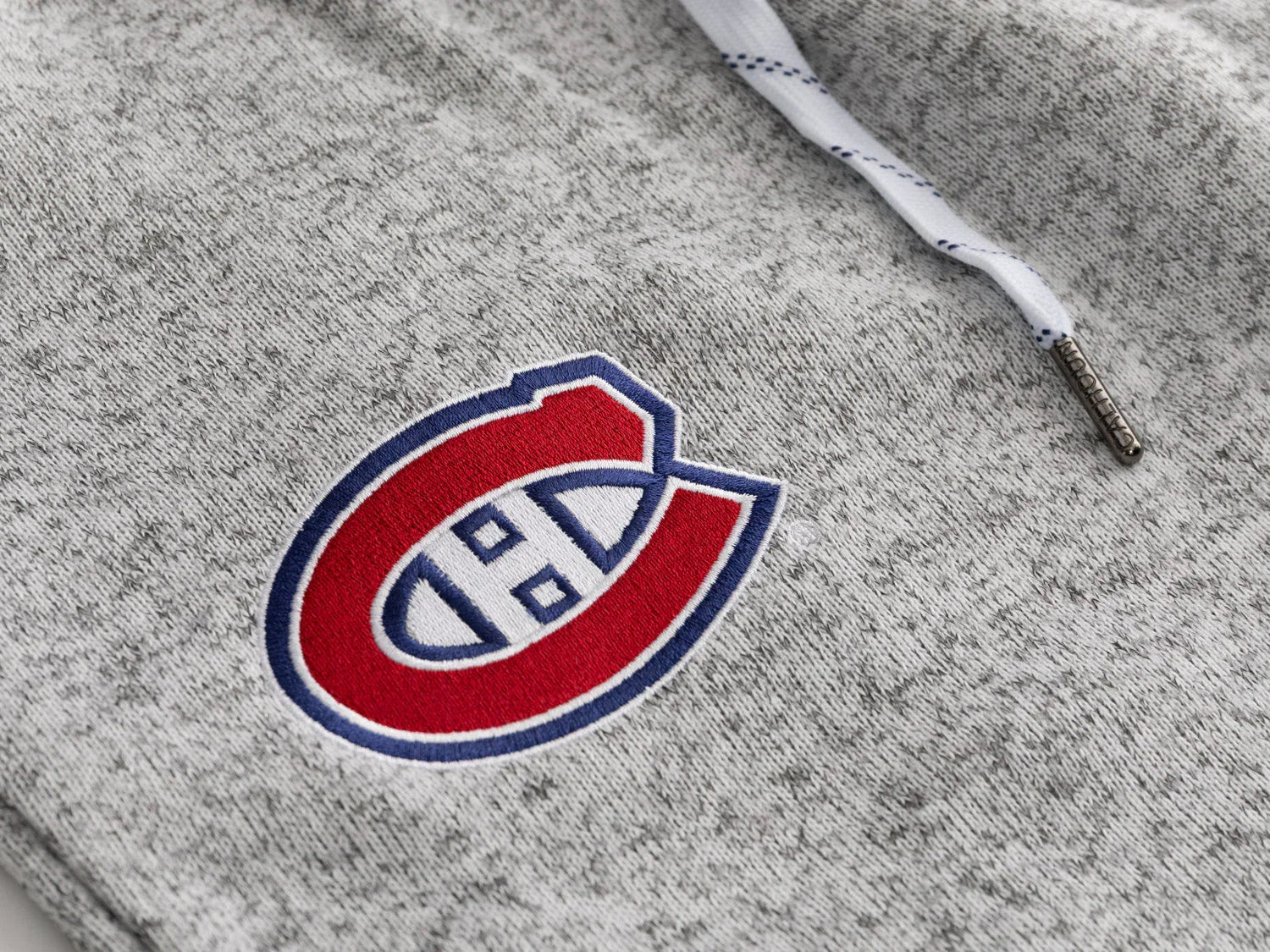 Montreal Canadiens logo on grey sweatpant fabric with white drawstring