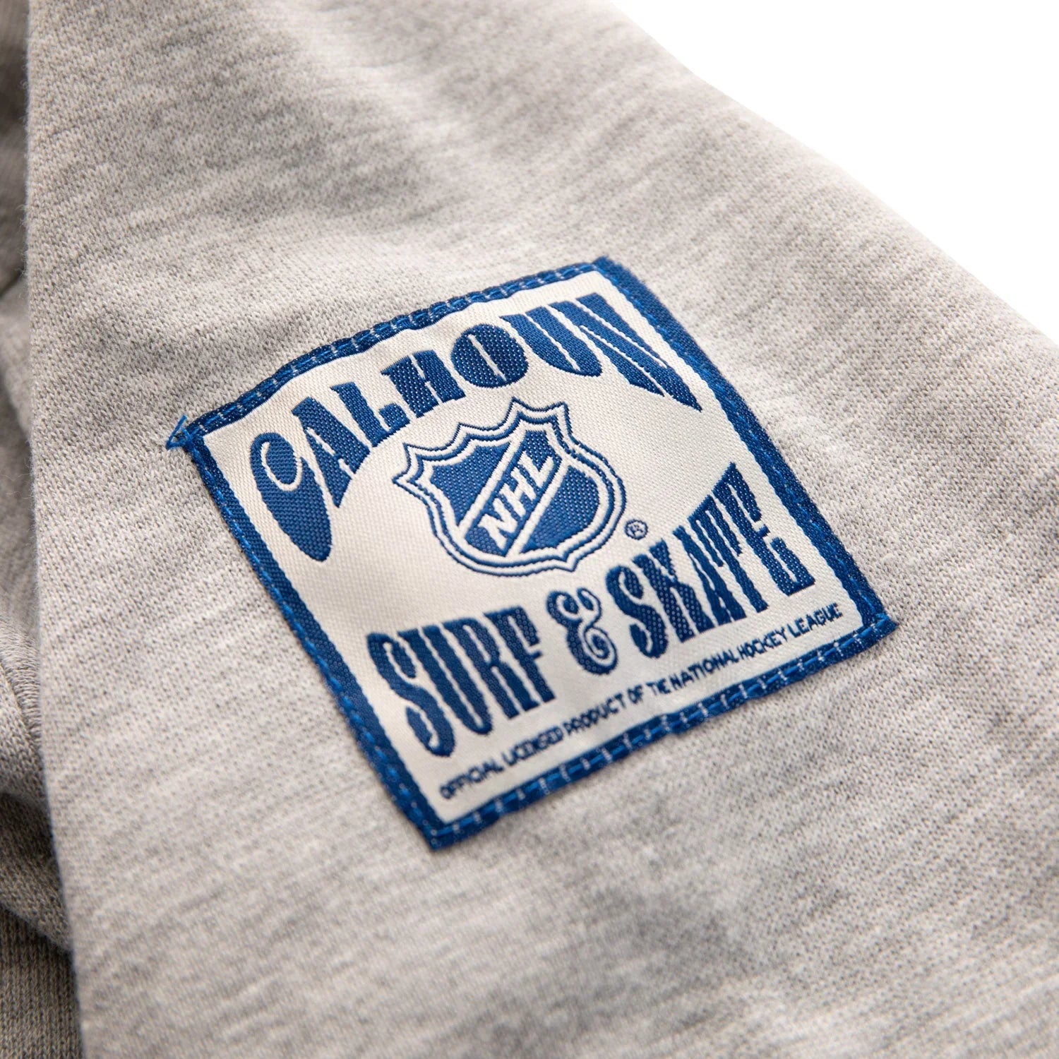 Calhoun NHL Surf & Skate patch on light grey sweatshirt fabric