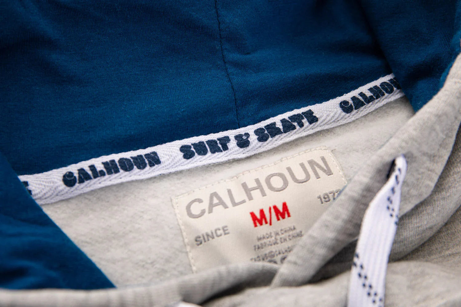 Calhoun navy hoodie interior label and surf & skate trim detail closeup