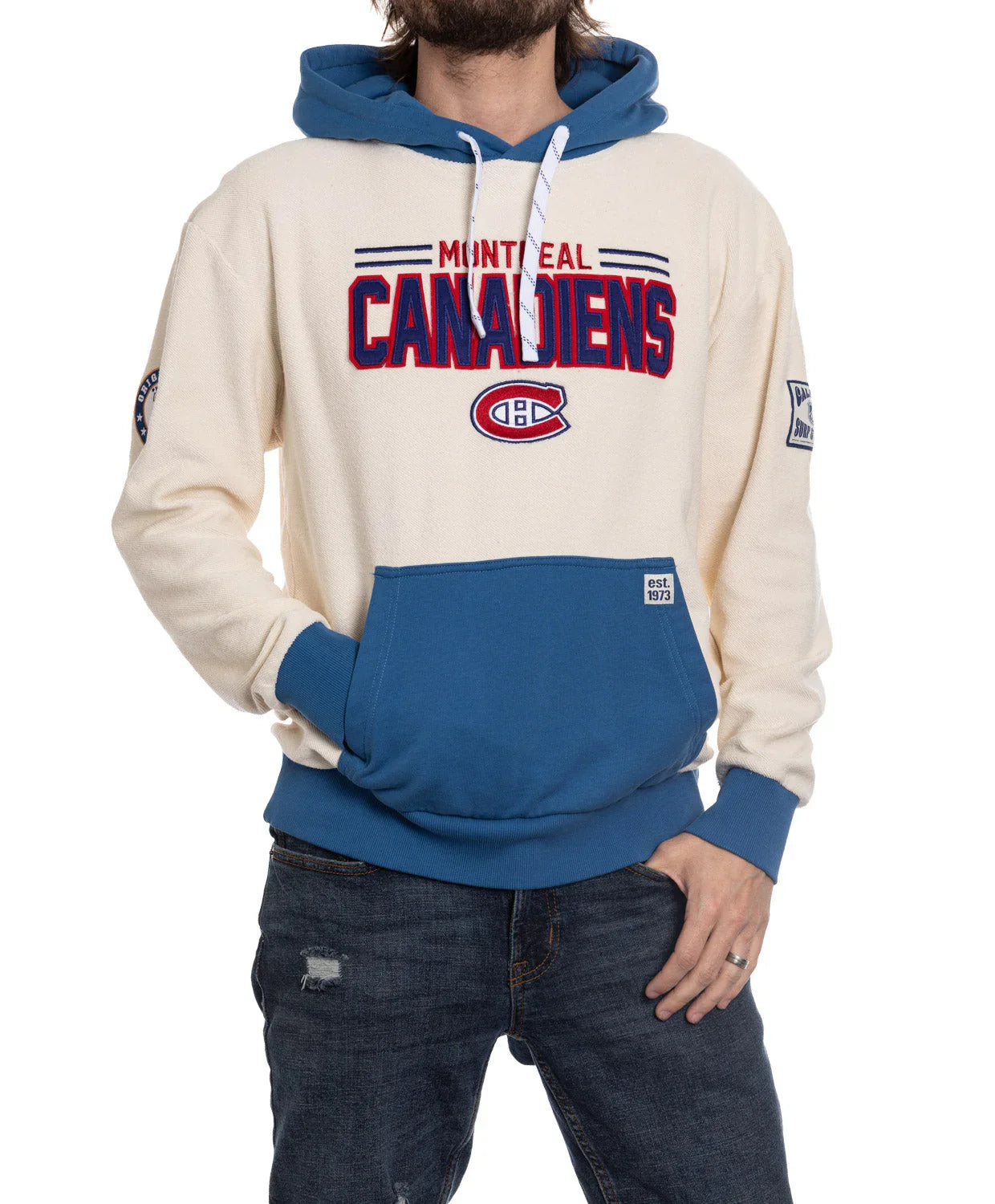 Montreal Canadiens cream and blue hoodie with team logo, worn by a man in jeans