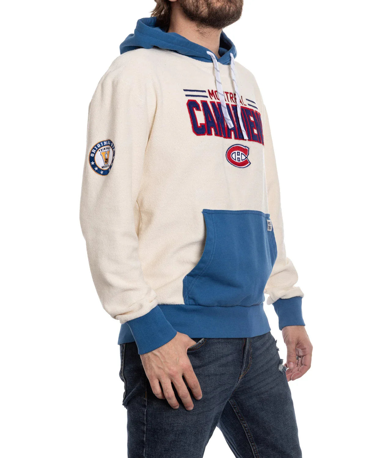 Man wearing Montreal Canadiens cream and blue hoodie with logo and patch on sleeve