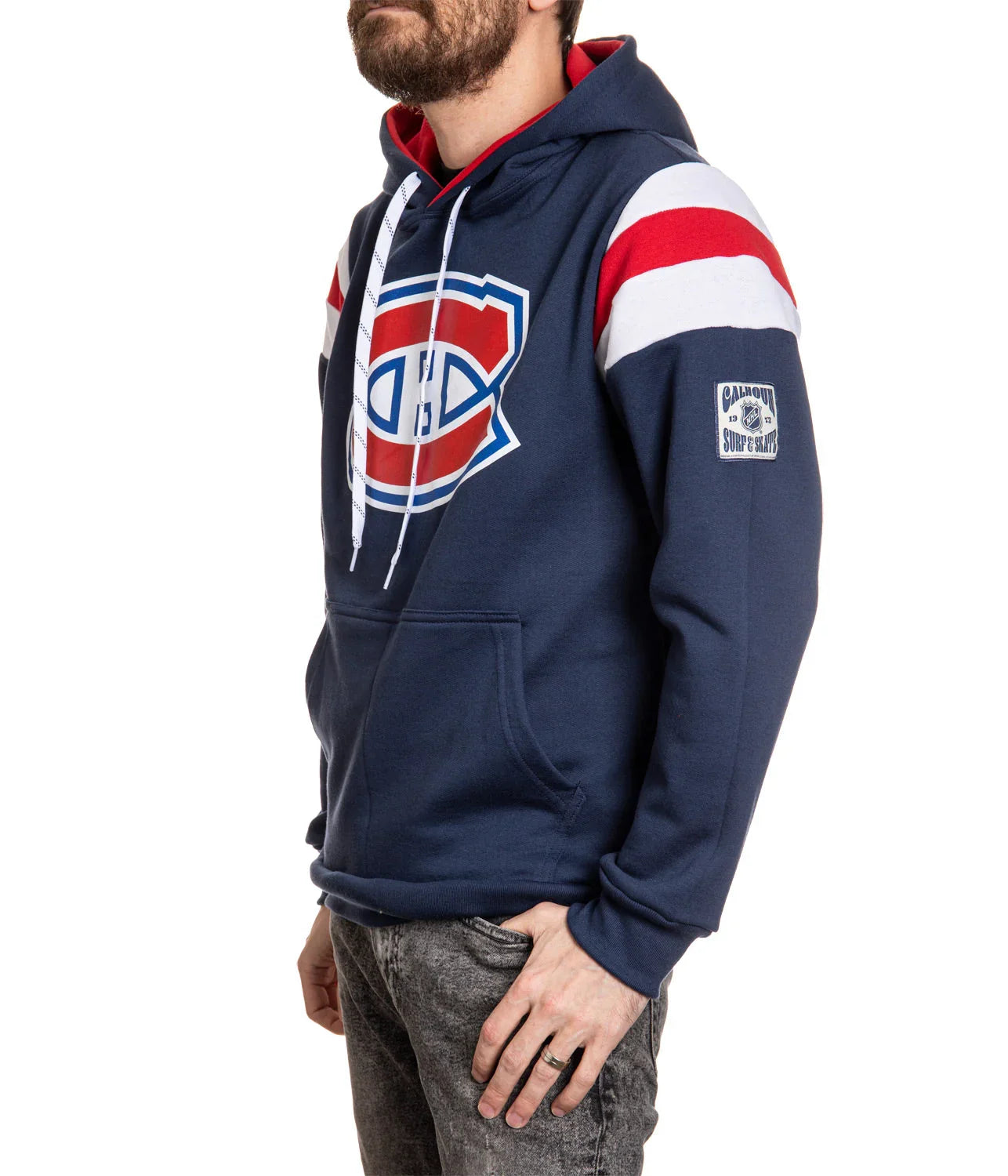 Man wearing navy Montreal Canadiens hoodie with red and white stripes and logo patch