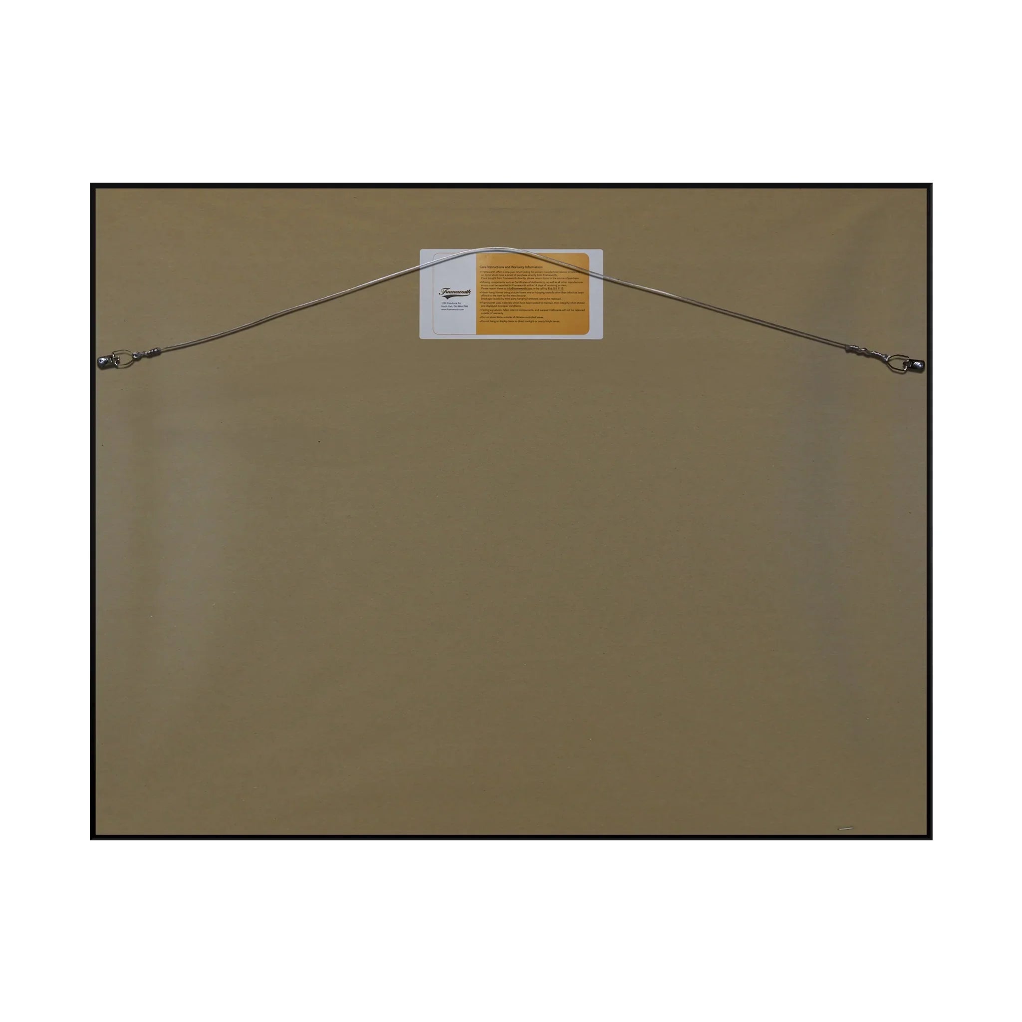 Back of a framed wall art print with hanging wire and attached label