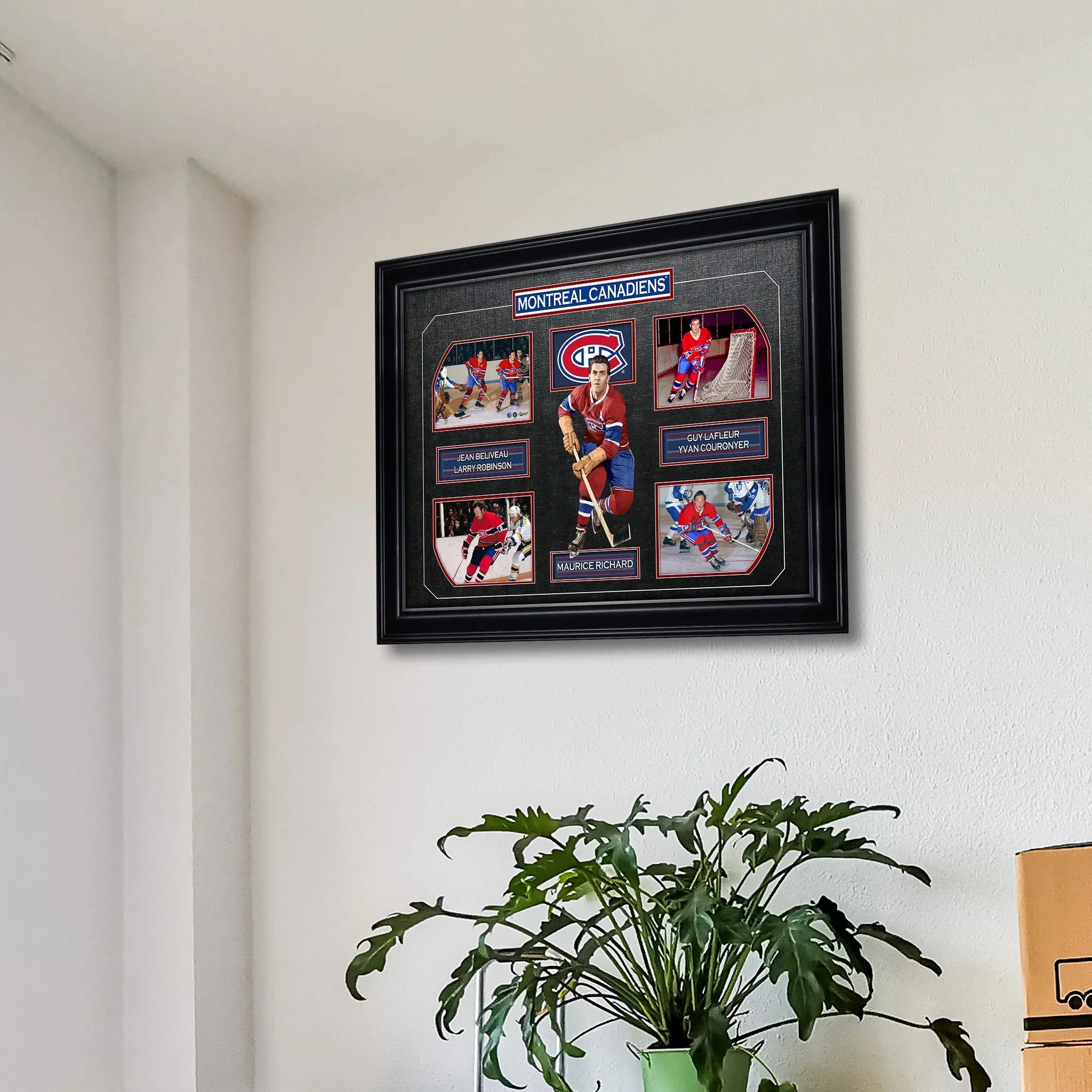 Framed Montreal Canadiens hockey legends collage on a white wall above a green houseplant