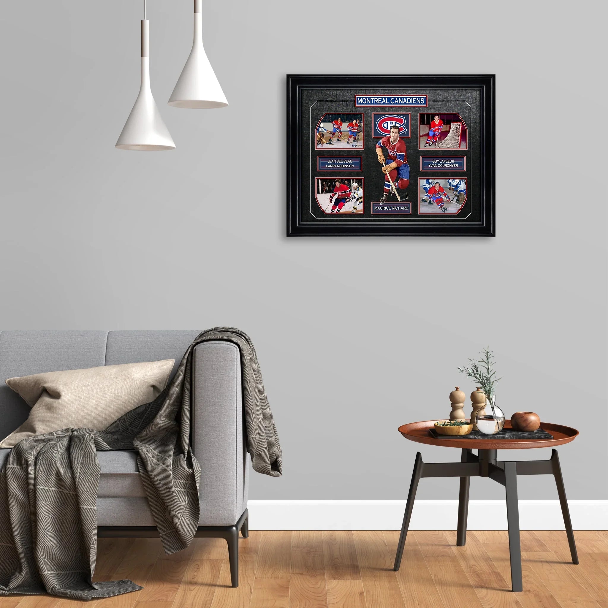 Framed Montreal Canadiens hockey memorabilia on living room wall above gray sofa