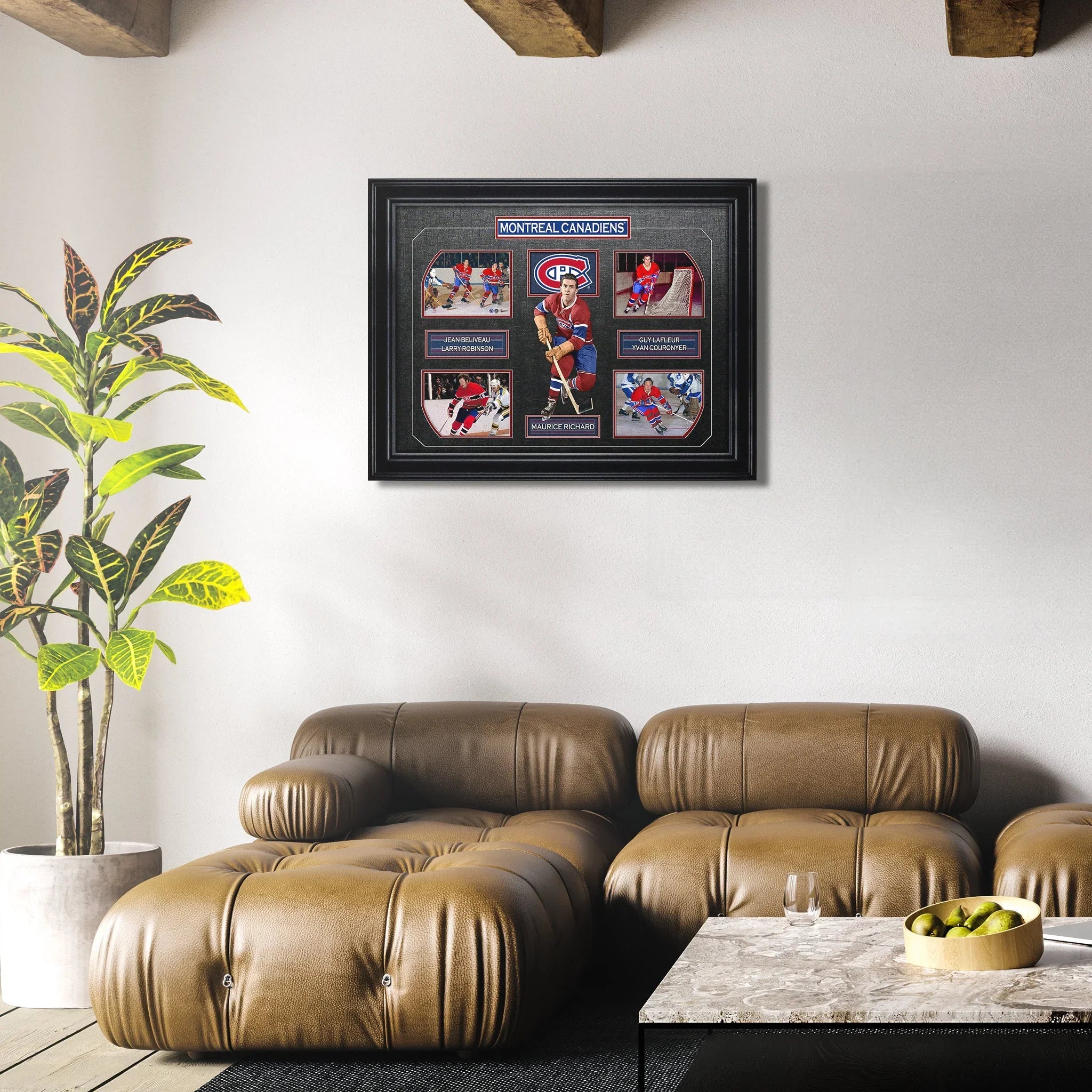 Modern living room with brown leather sofa, framed Montreal Canadiens hockey art on white wall