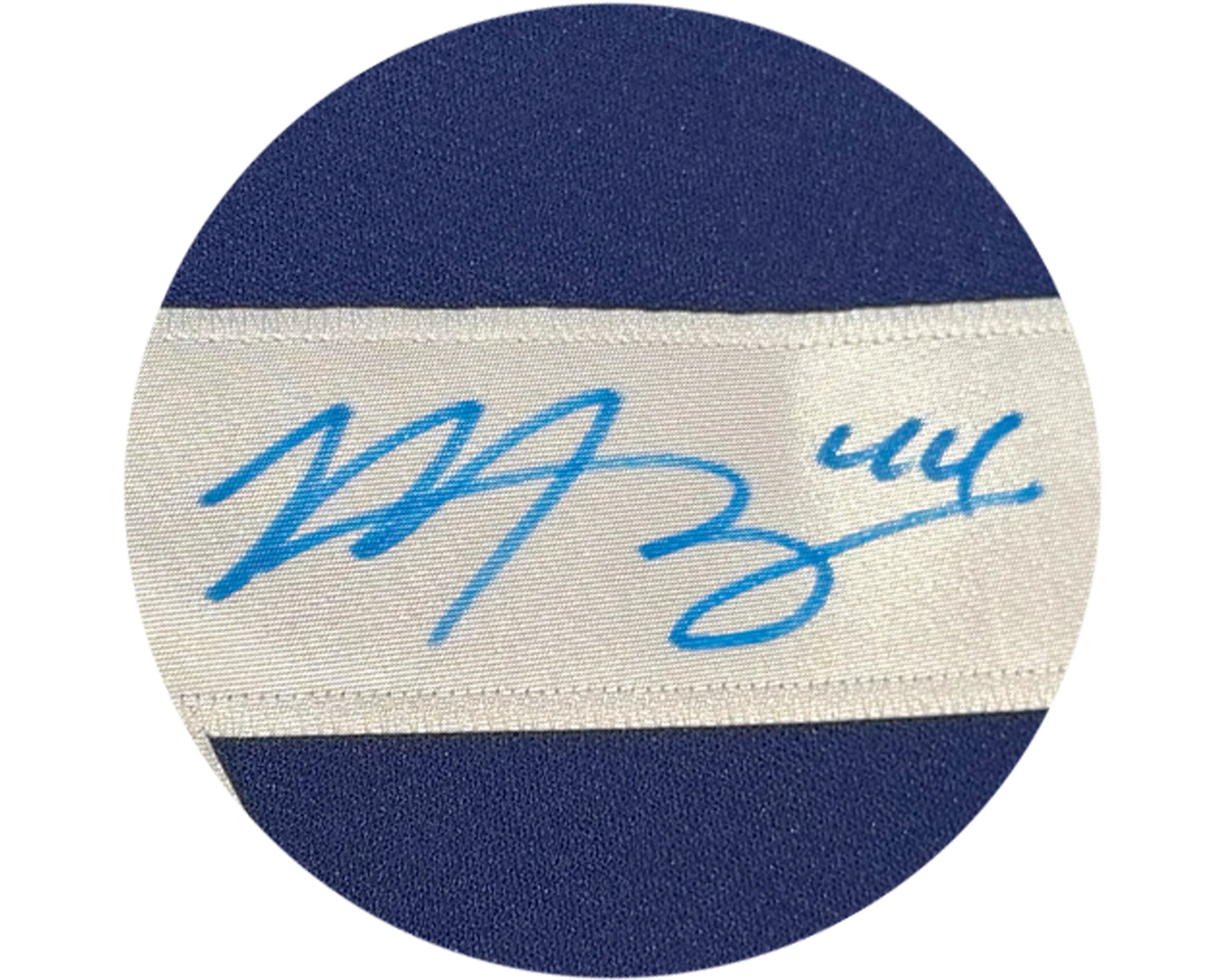 Blue autograph on white fabric label stitched to blue cloth background