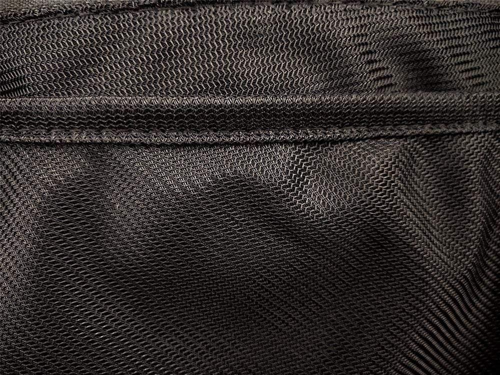Close-up of black mesh mosquito net fabric with visible stitching, hammock accessory detail