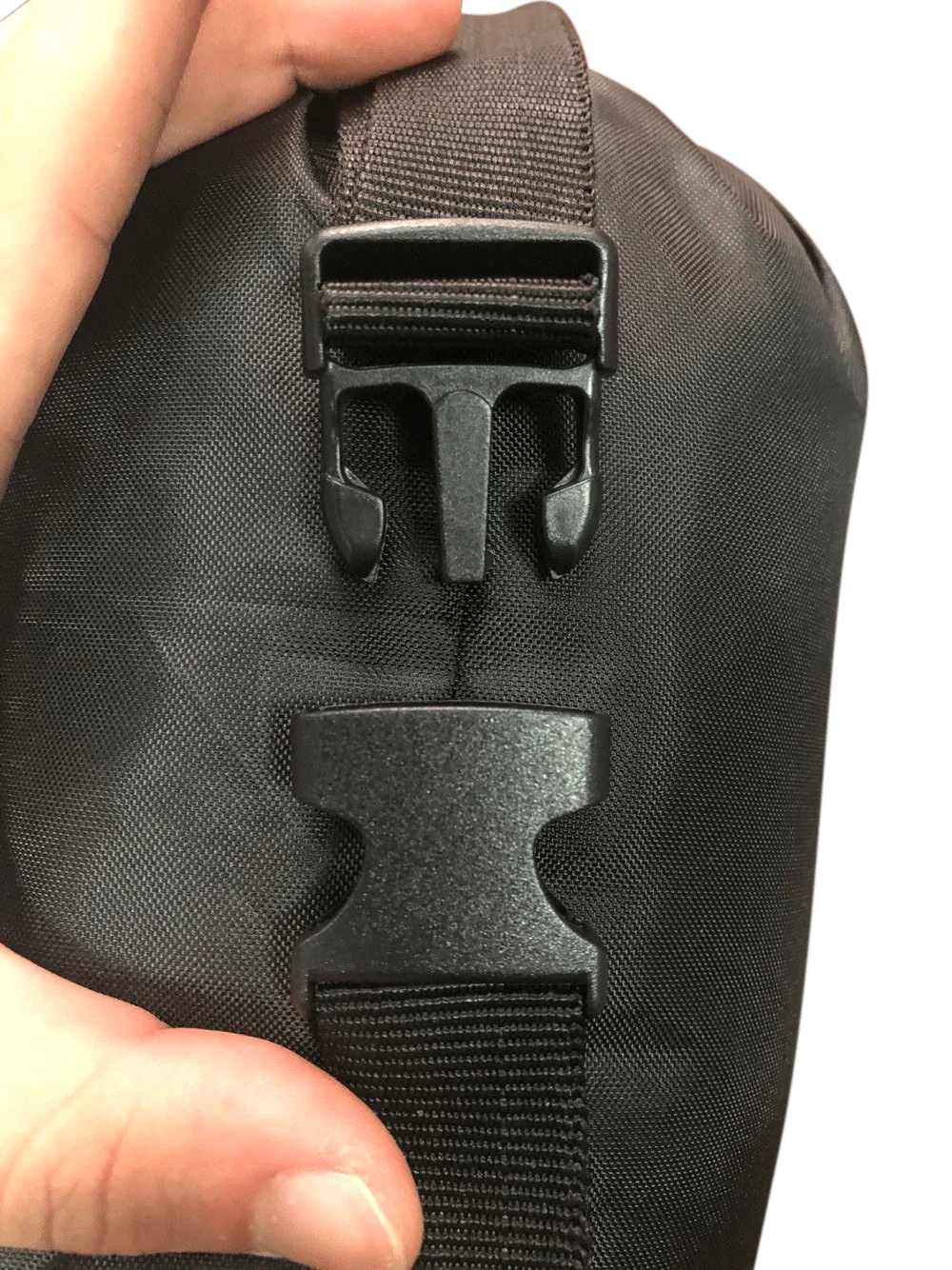 Close-up of black hammock mosquito net carry bag with plastic clip and strap