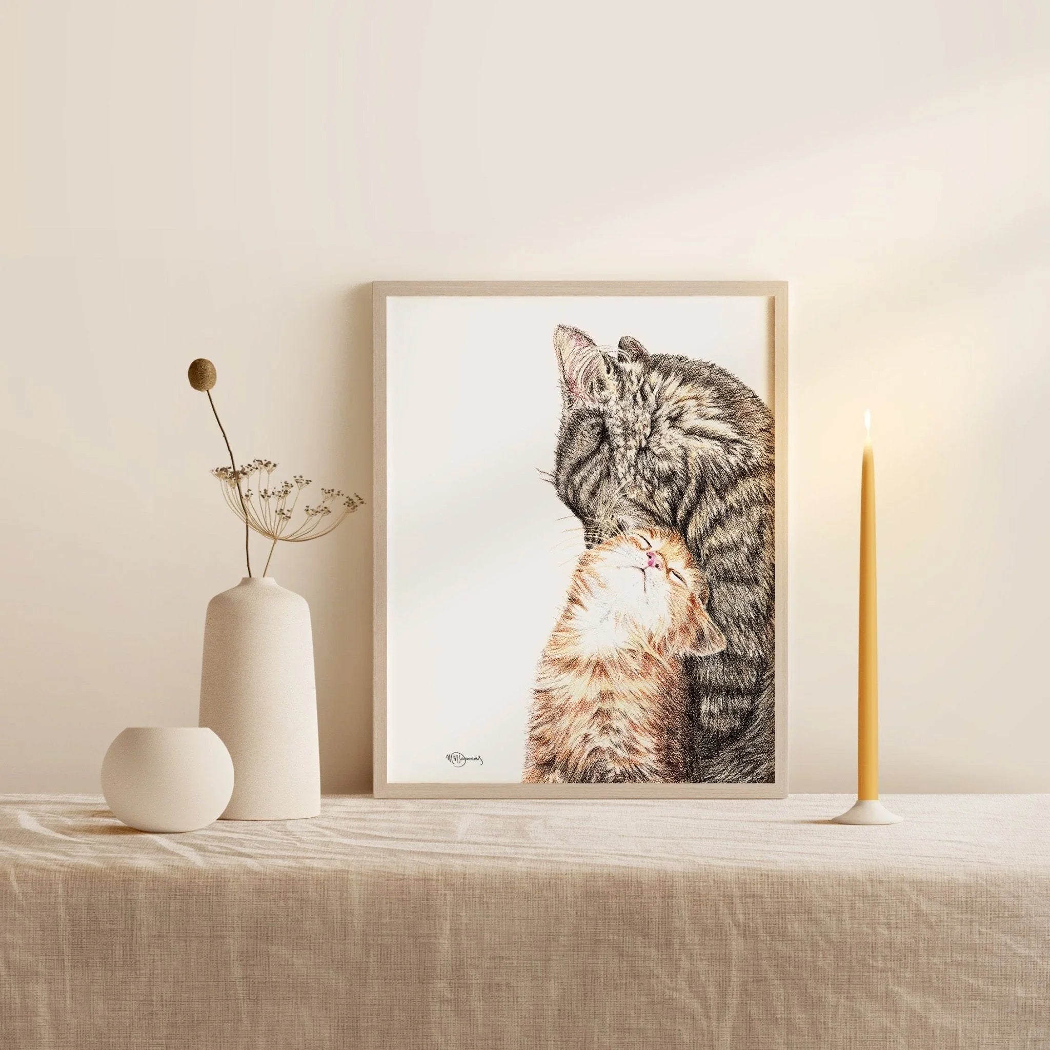 Framed mother cat with kitten art on beige table, minimalist home decor setting