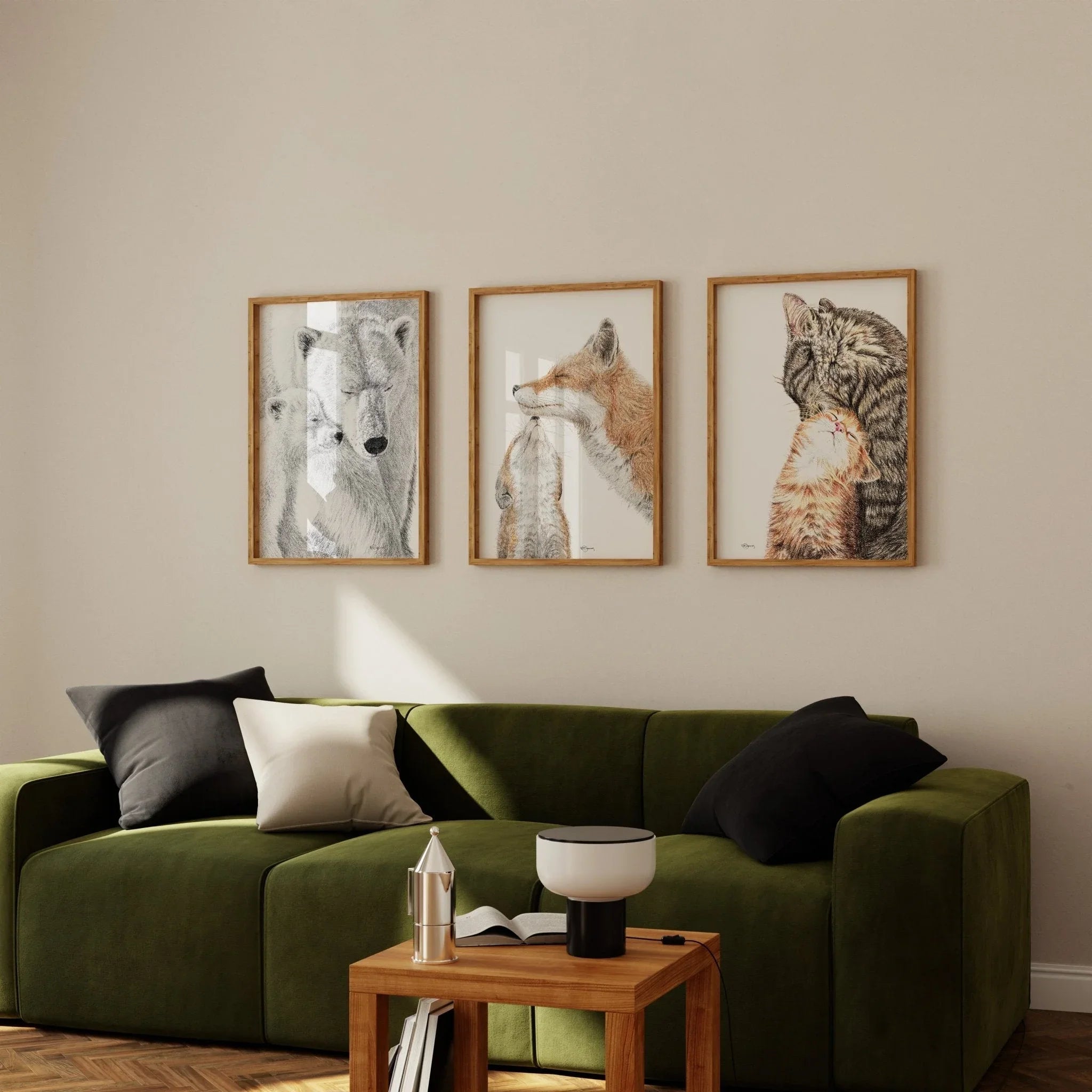 Modern living room with green sofa, wooden table, and cat-themed wall art prints