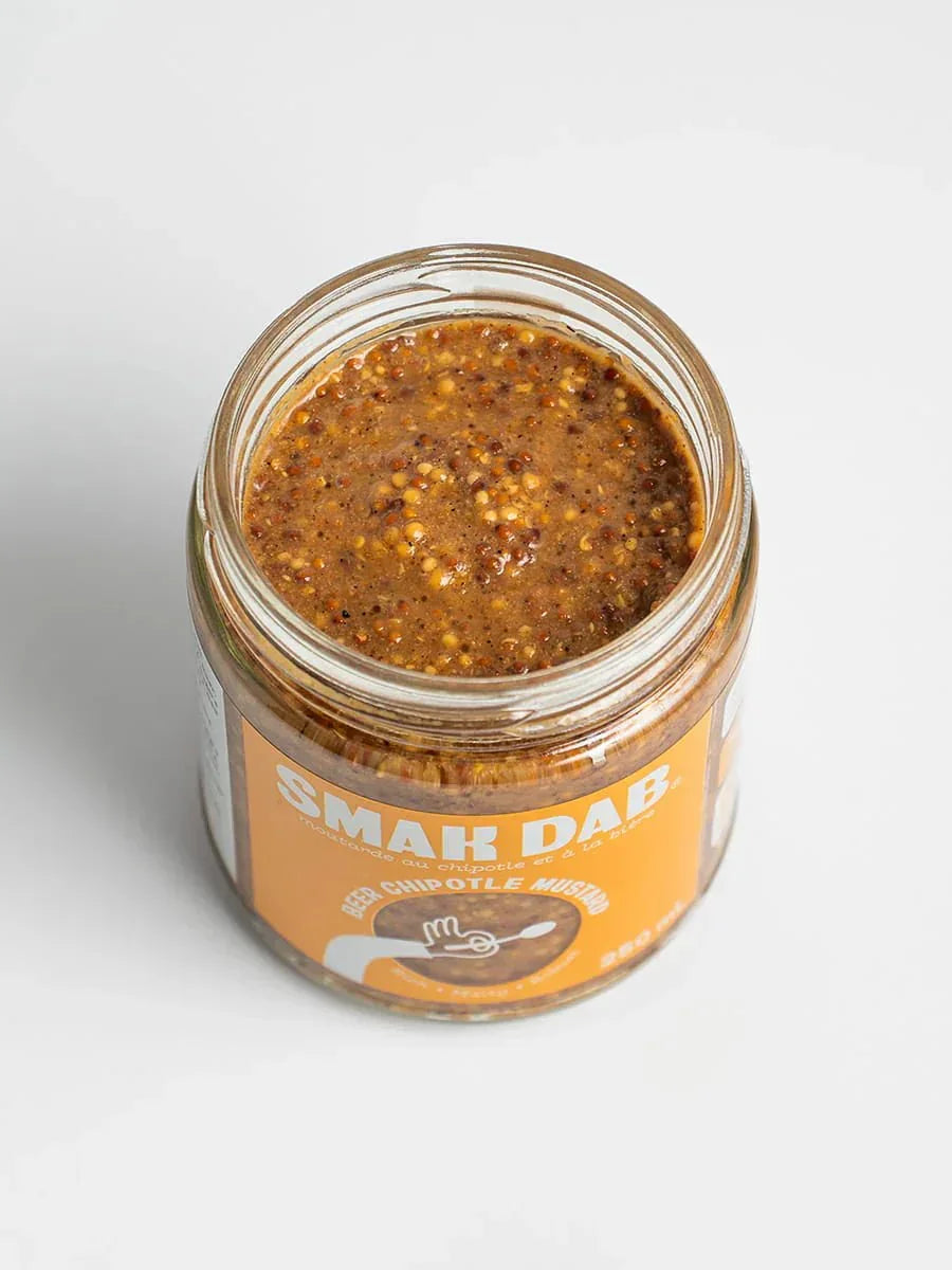 Open jar of Smak Dab beer chipotle mustard on a white background