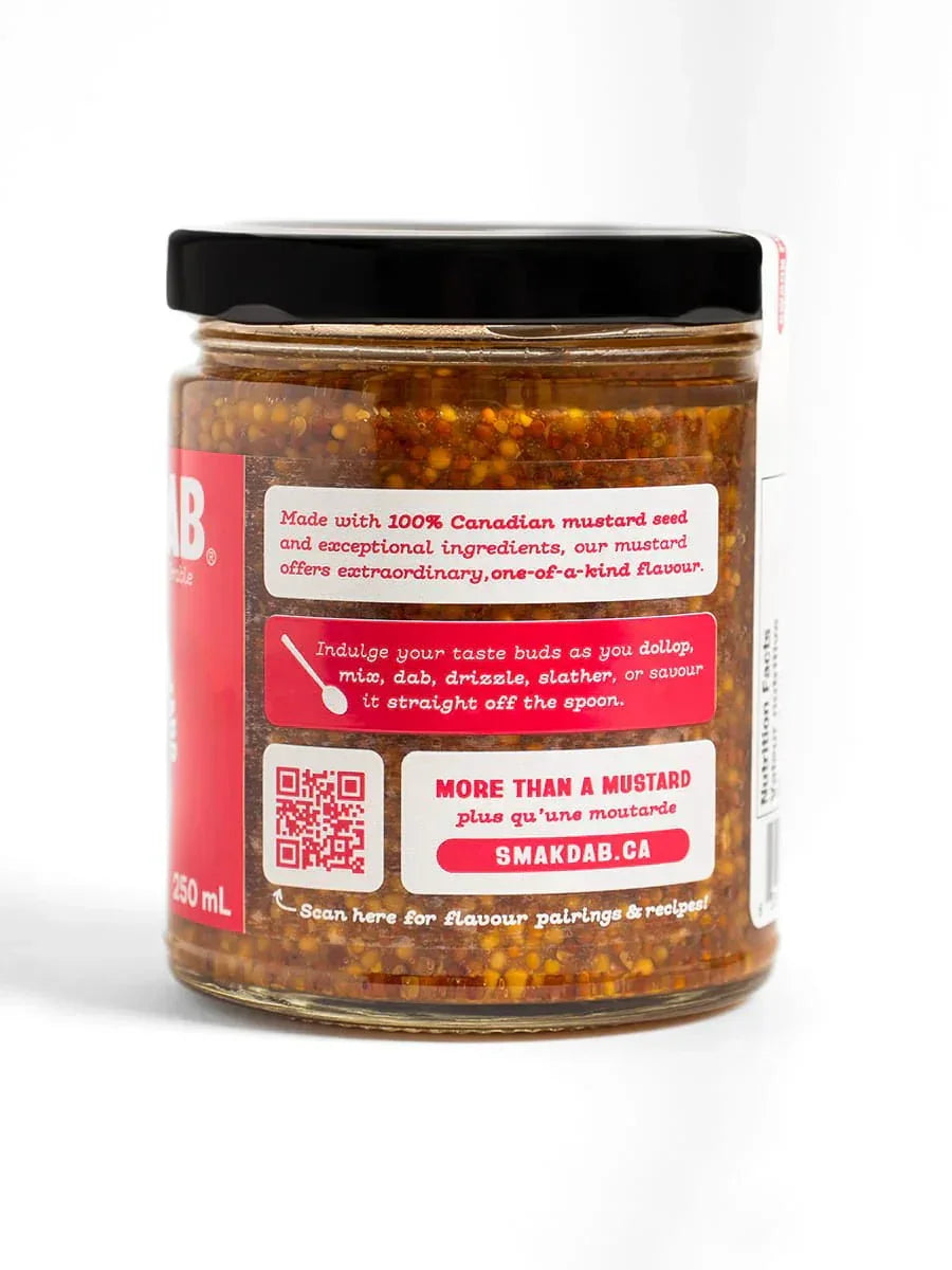 Glass jar of Smak Dab Canadian mustard seed with flavor notes and website logo on white background