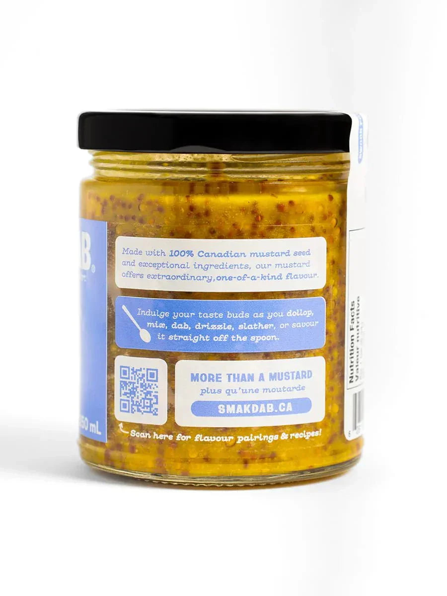 Jar of Smak Dab Canadian mustard with yellow seeds and blue label on white background