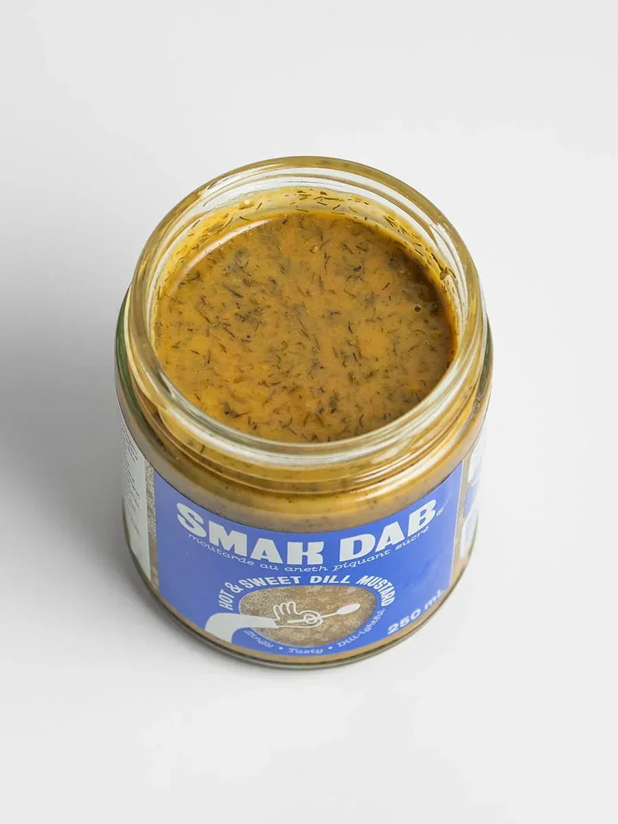 Open jar of Smak Dab hot and sweet dill mustard on white background
