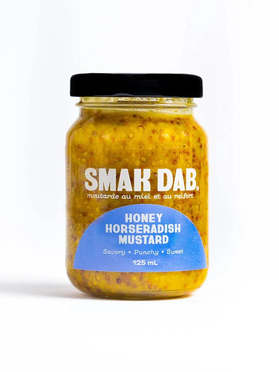 Jar of Smak Dab honey horseradish mustard with black lid on white background