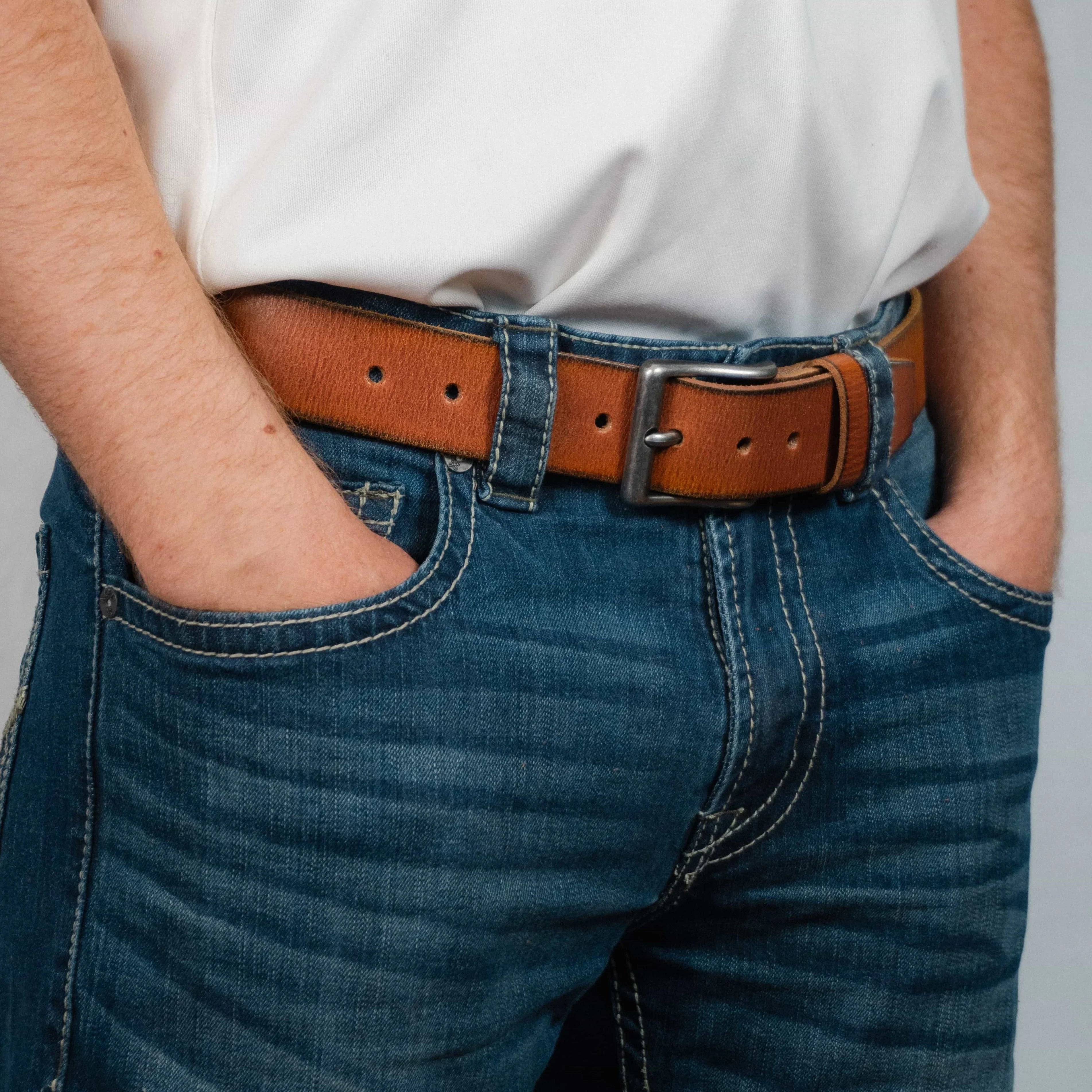 Brown leather belt on blue jeans with white shirt, casual fashion accessory