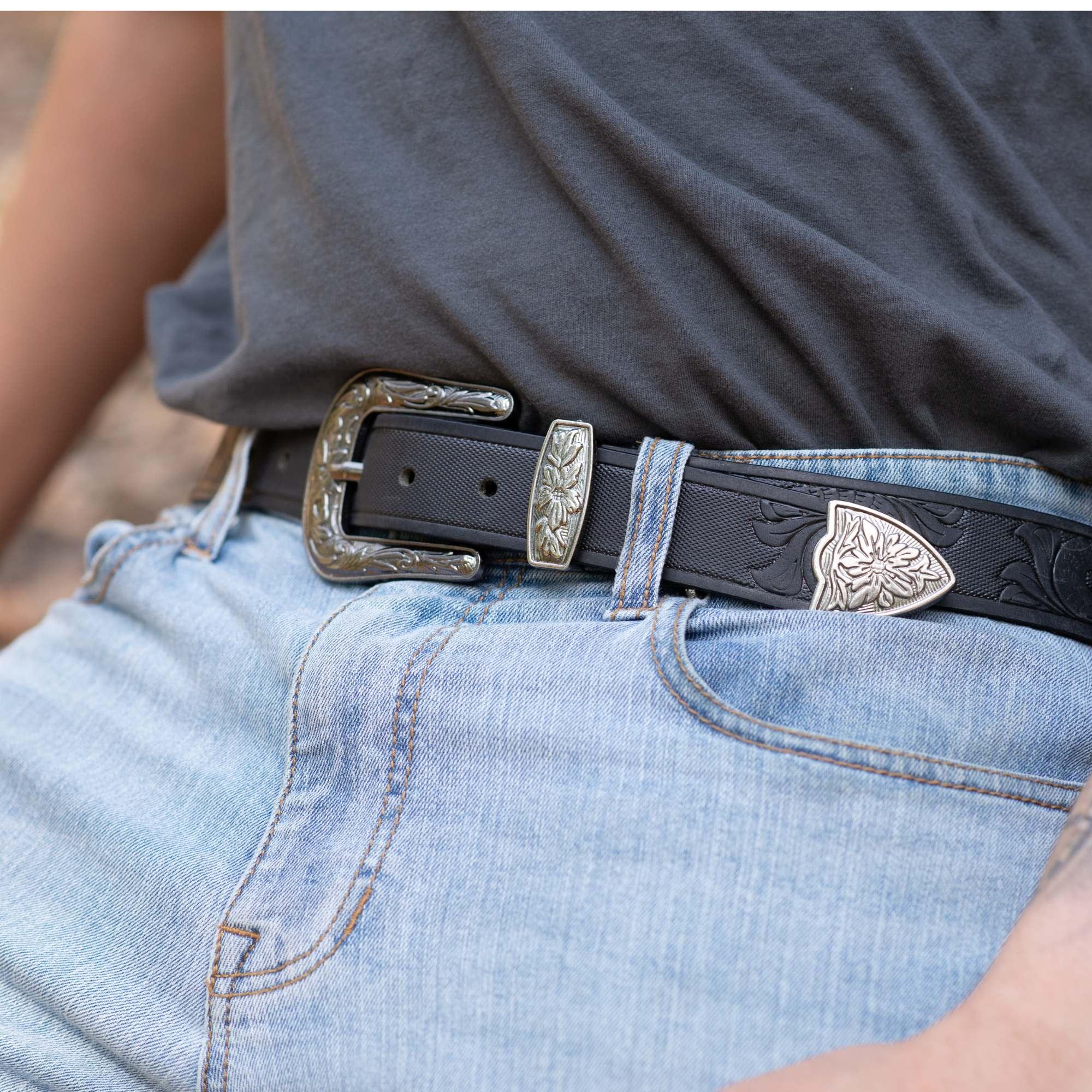 Black western belt with engraved silver buckle on light blue jeans