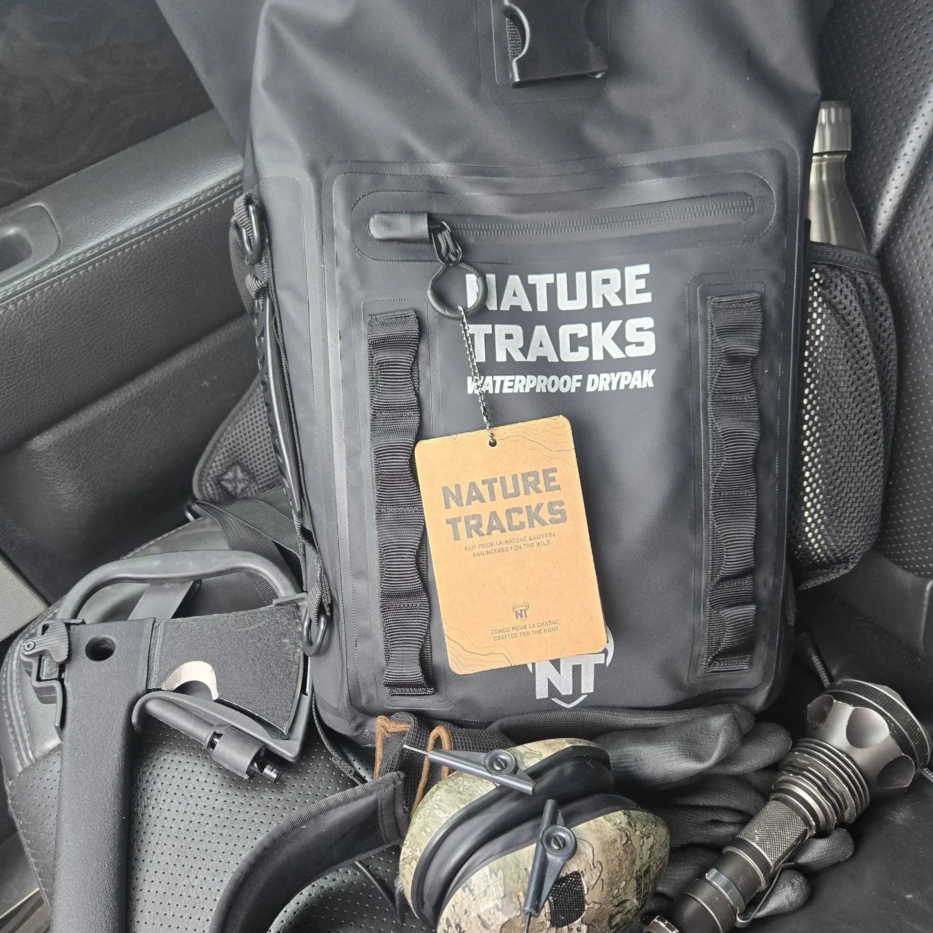 Nature Tracks waterproof dry bag with outdoor gear on a car seat