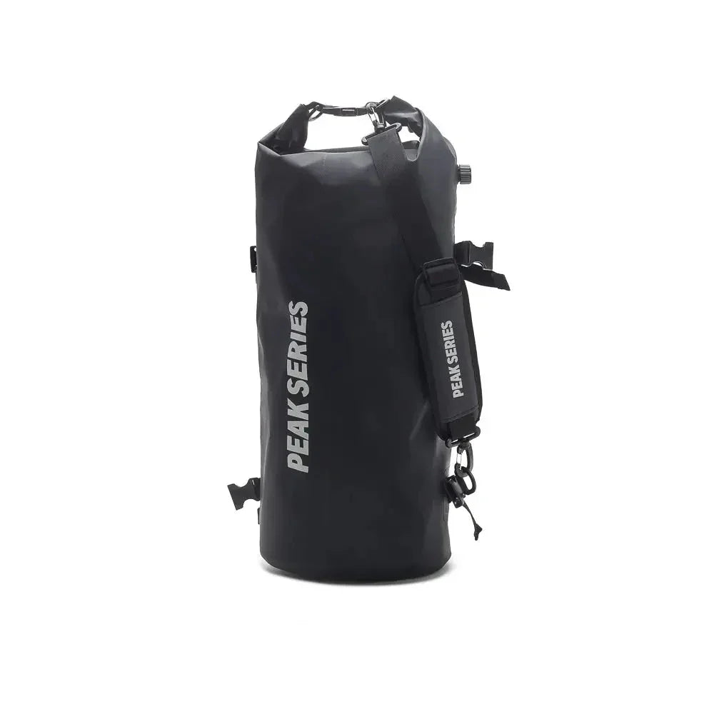 Black PEAK SERIES waterproof dry bag with shoulder strap on white background
