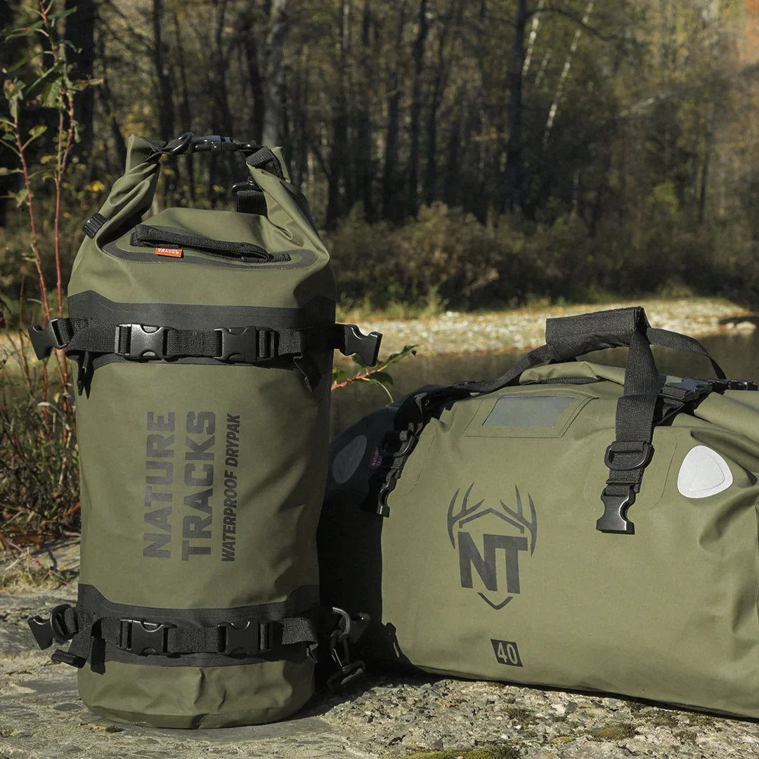 Nature Tracks waterproof dry bag and duffle bag in green, outdoors by a river