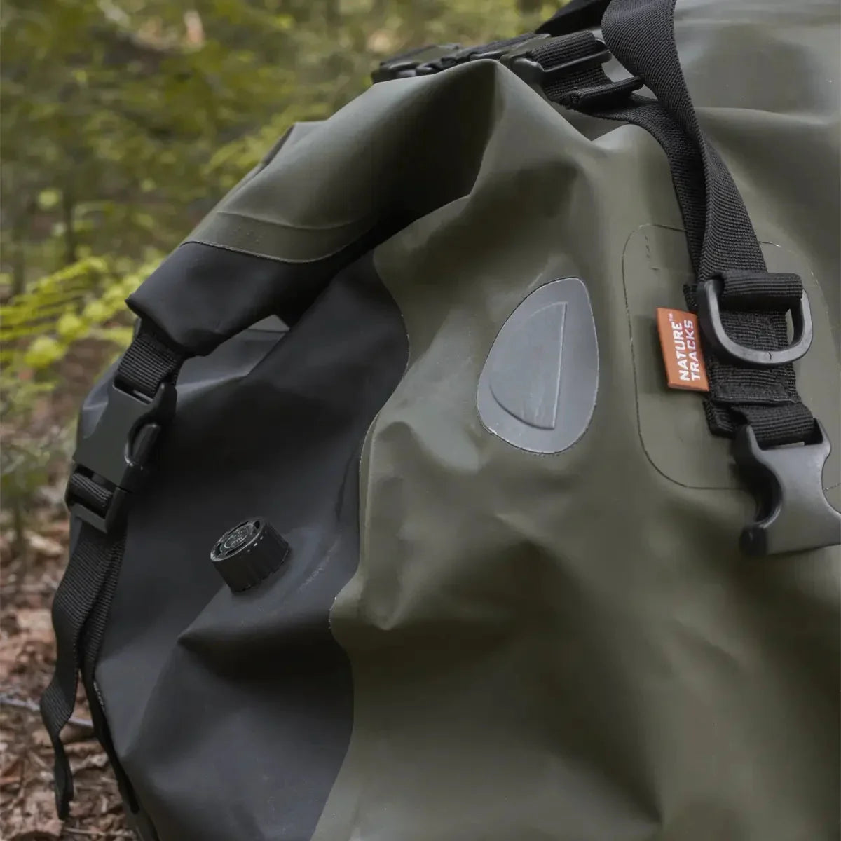 Nature Tracks Canada olive green waterproof weekender bag with black straps outdoors