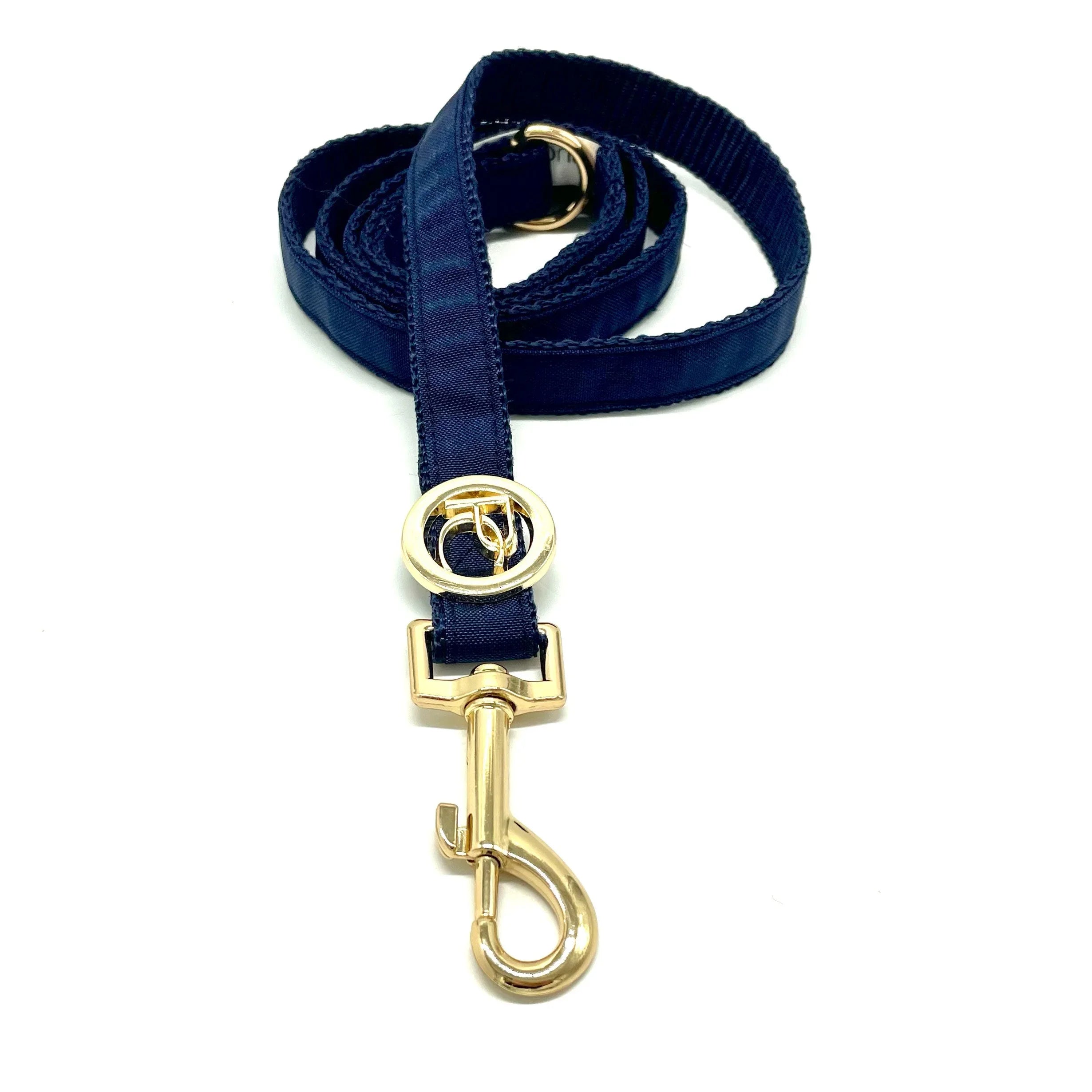 Blue dog leash with gold metal clasp and ring on white background