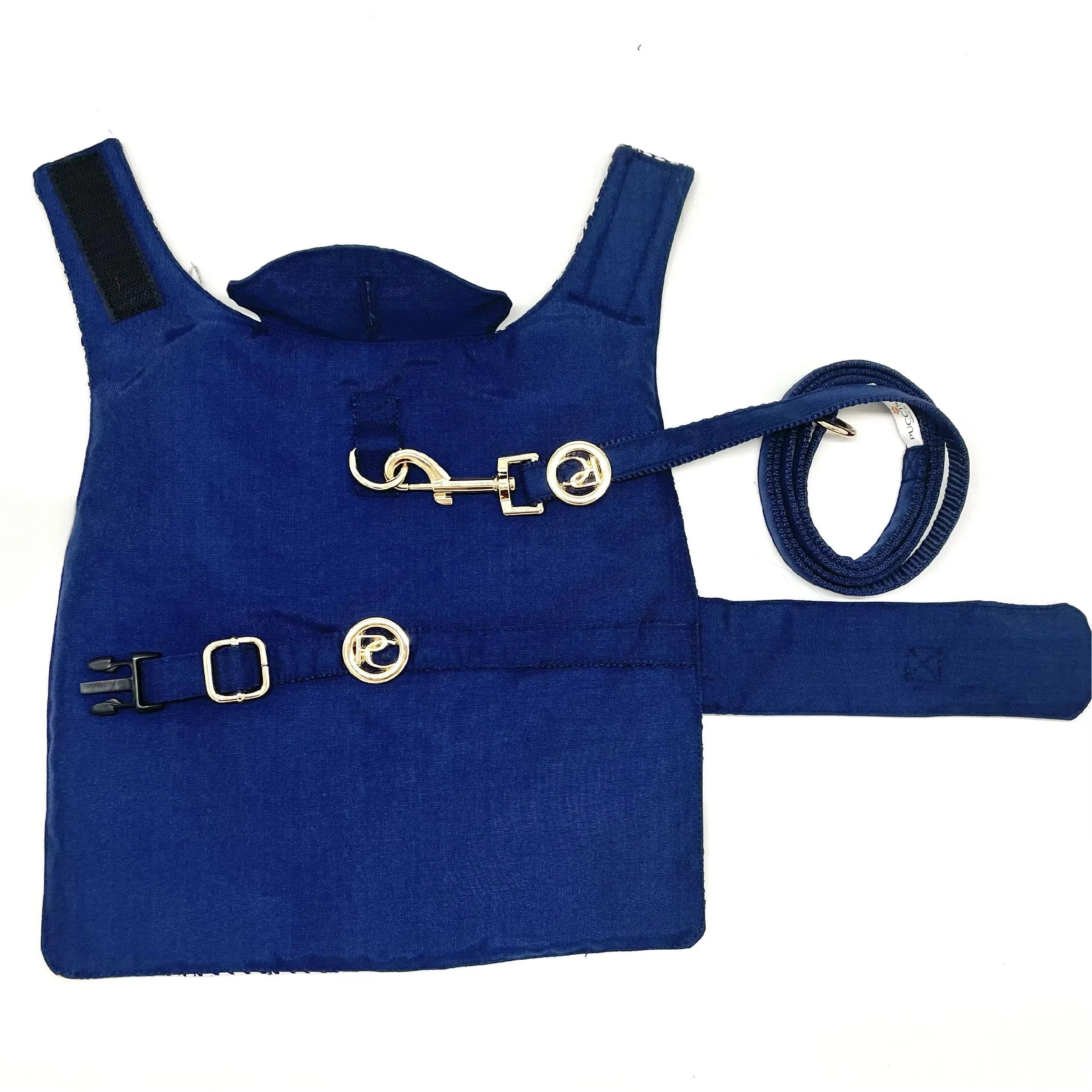 Blue pet harness with matching leash and silver buckles on white background