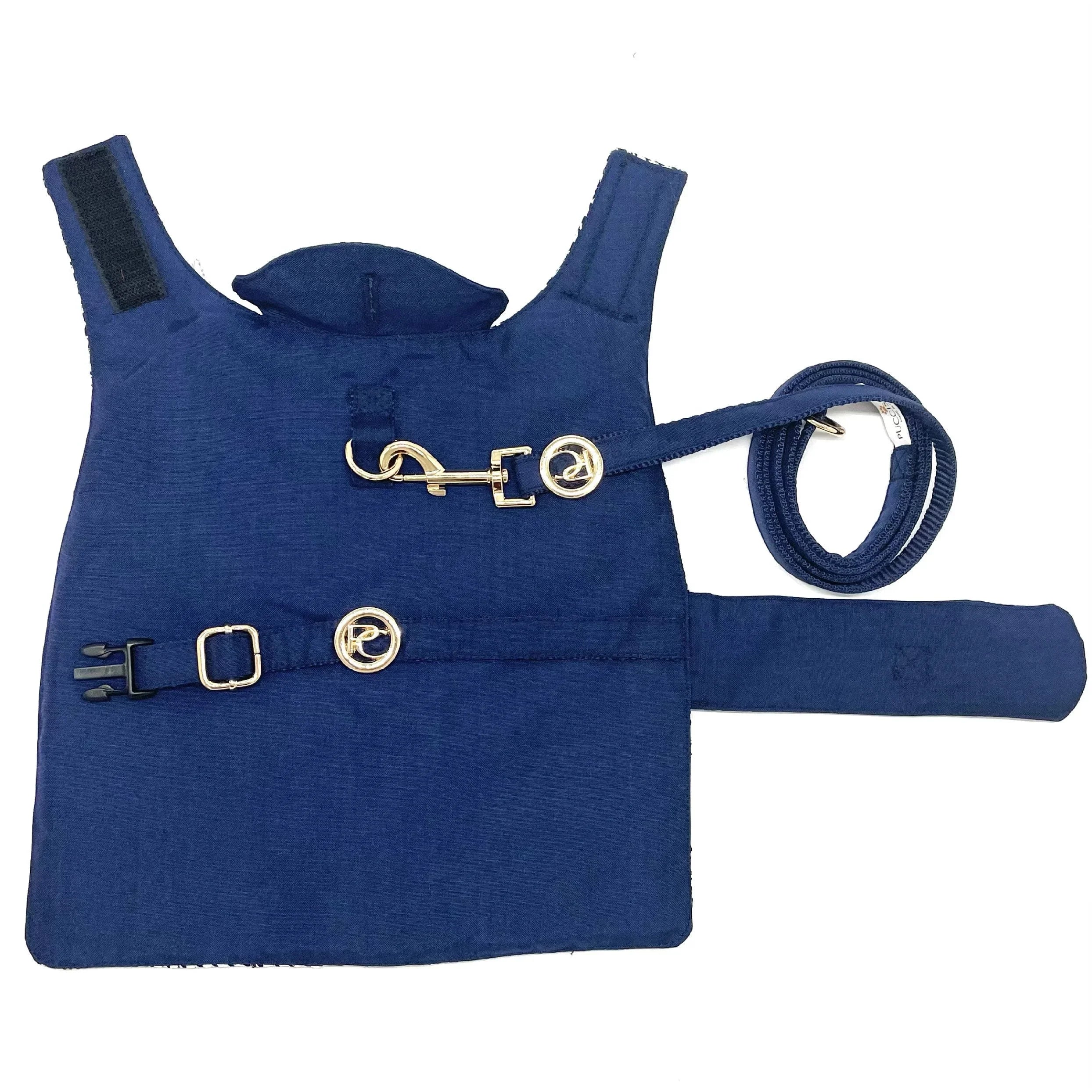 Navy blue dog harness and leash set with gold hardware on white background