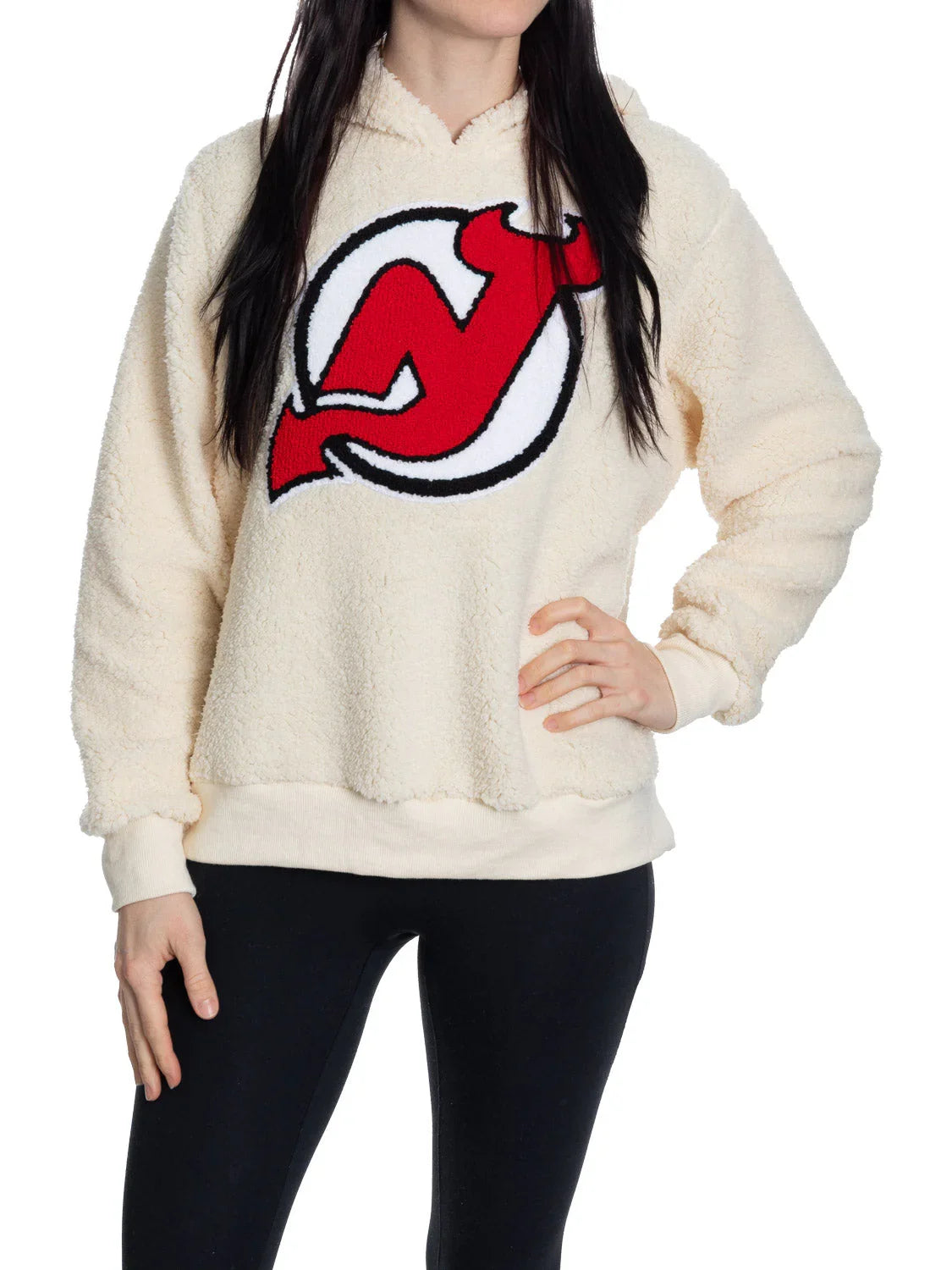 Woman wearing cream Devils sherpa hoodie with red NJ Devils logo on front