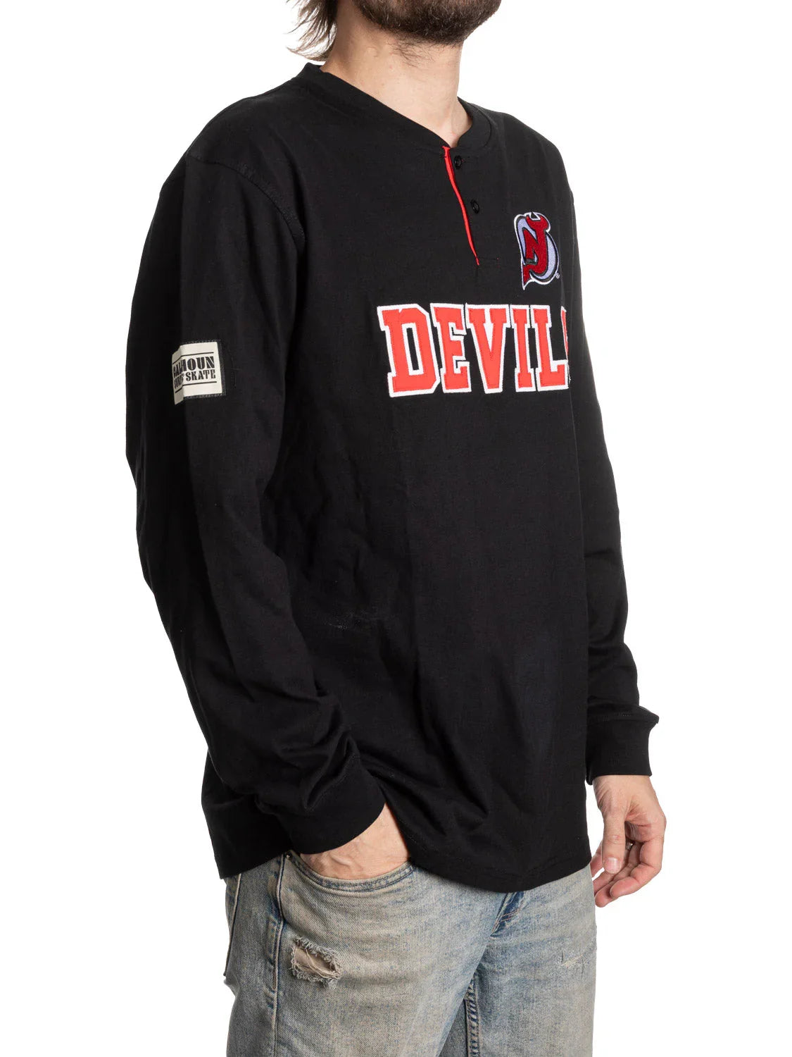 Black Devils Henley shirt with red logo and patch on sleeve, worn with ripped jeans