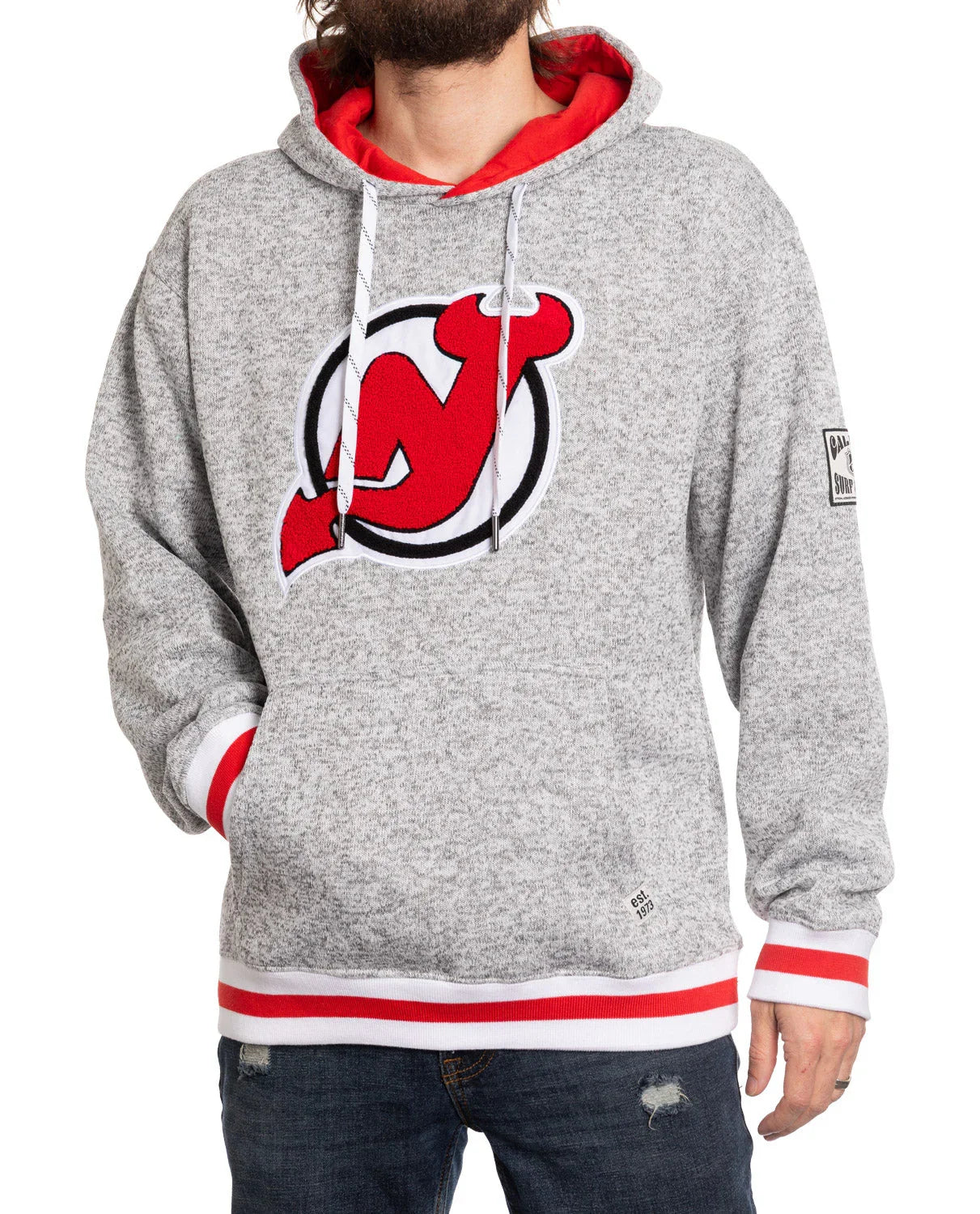 Gray New Jersey Devils hoodie with red logo, red-lined hood, worn by man in jeans
