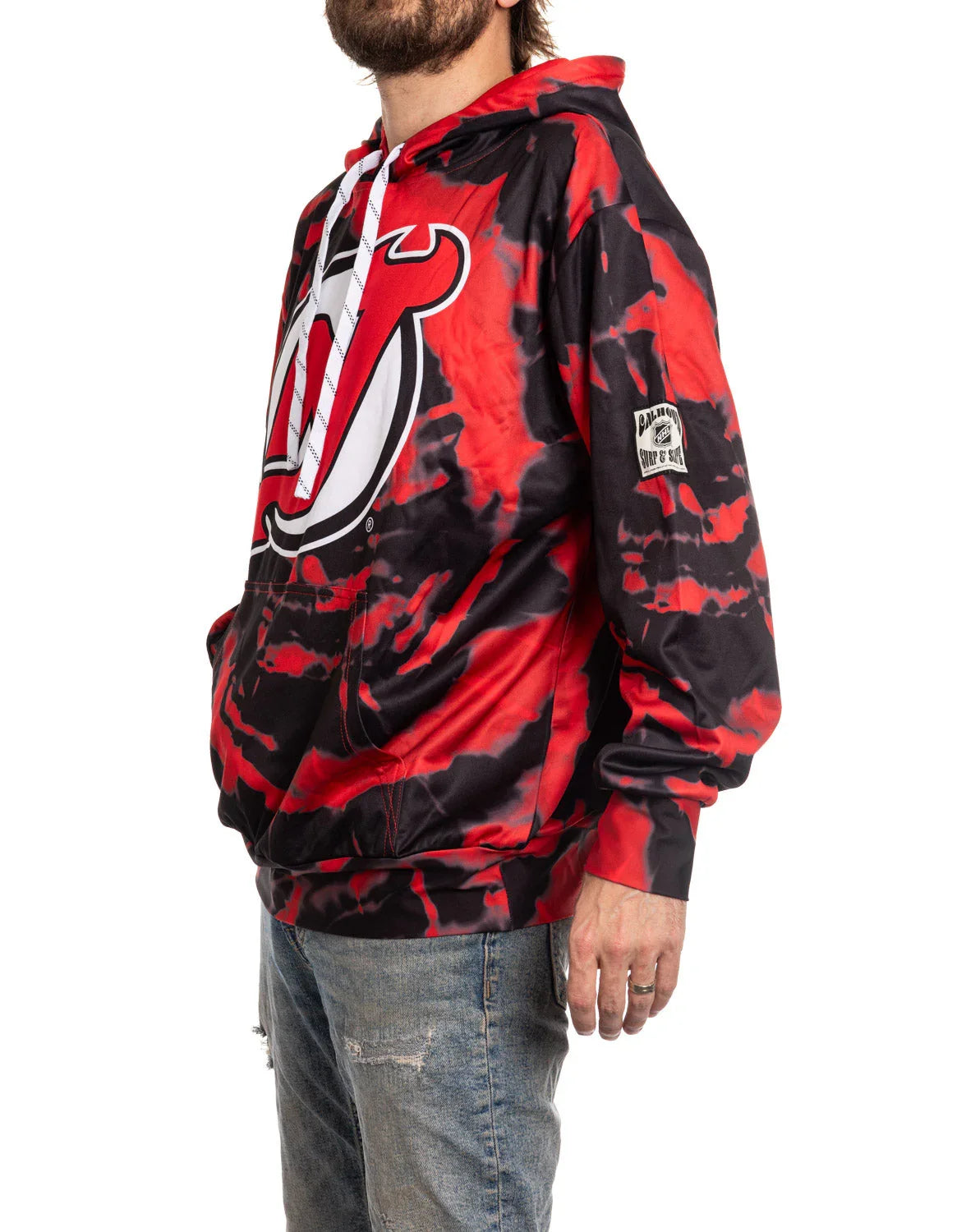 Man wearing red and black Devils sublimation hoodie with team logo and distressed jeans