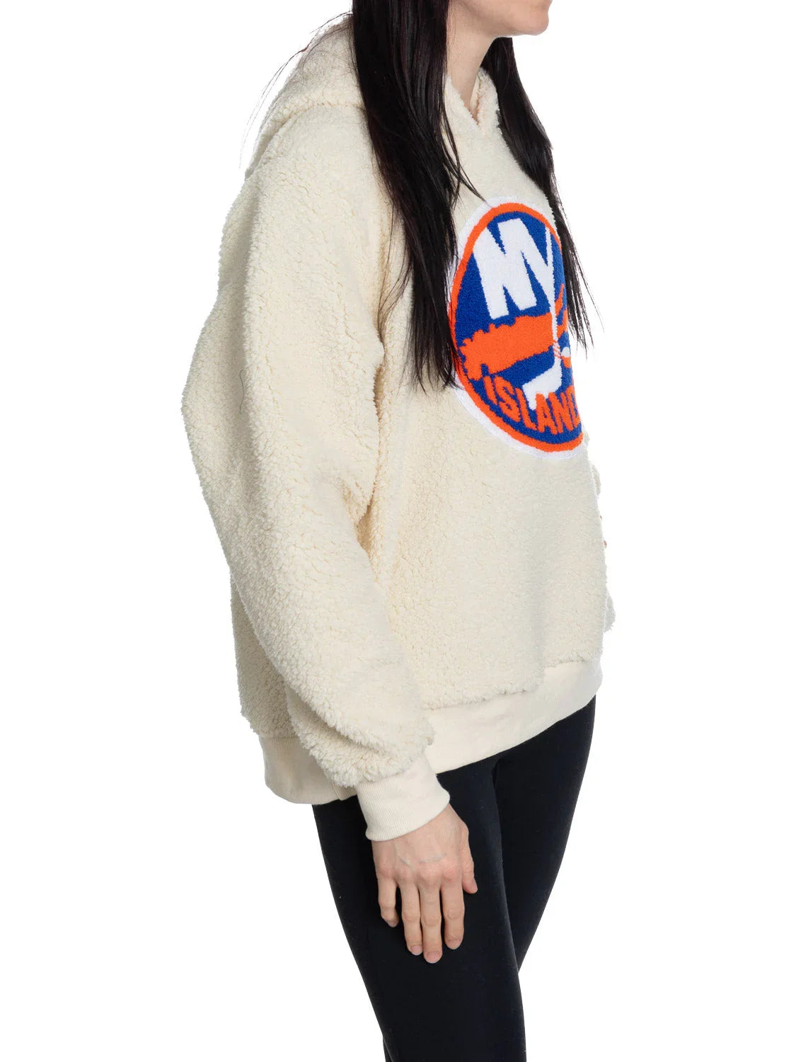 Woman wearing cream sherpa hoodie with New York Islanders logo, side view